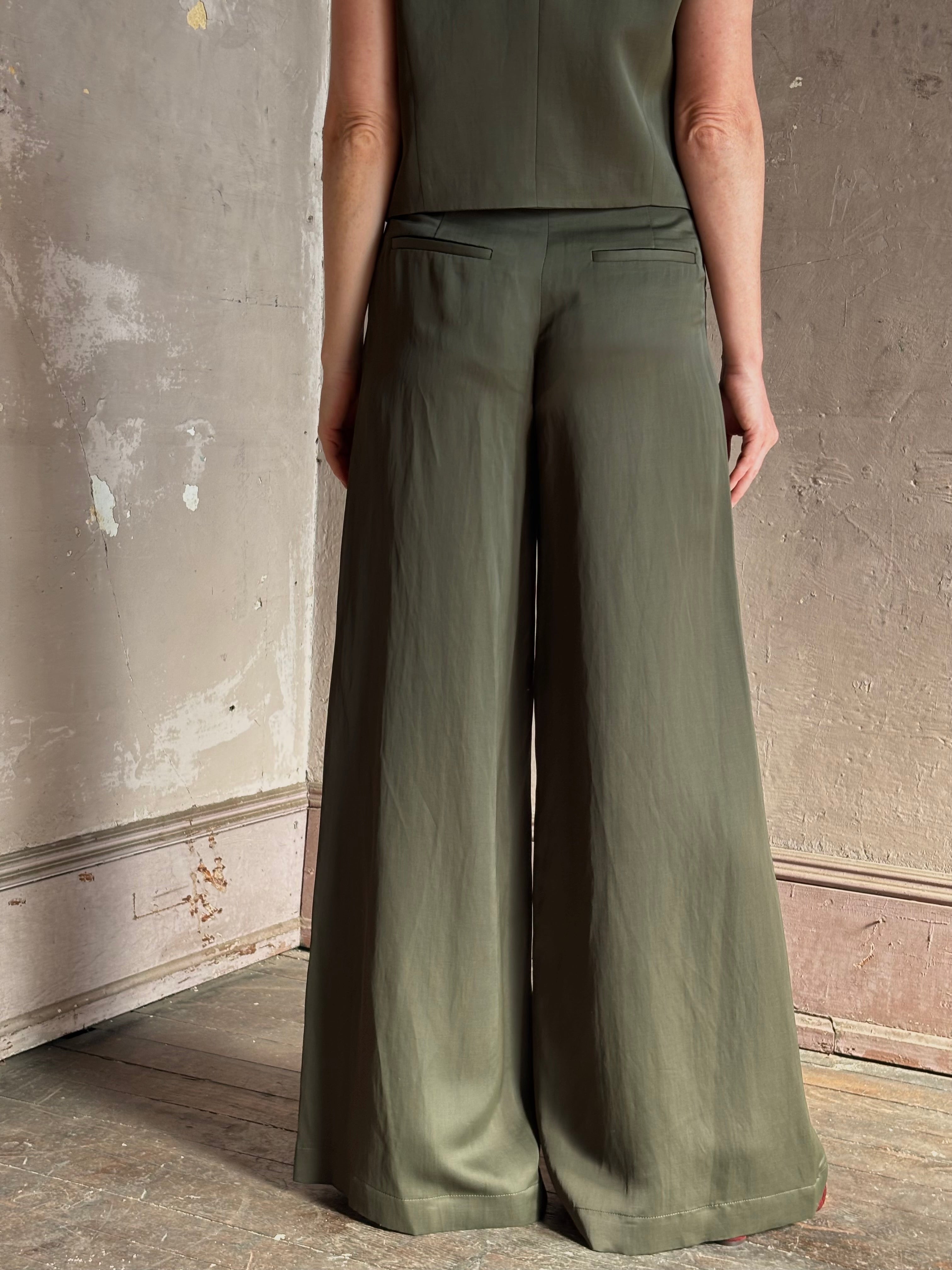 Mature woman wearing luxury women's clothing brand TWP Green Demie wide leg trouser linen viscose blend fabric