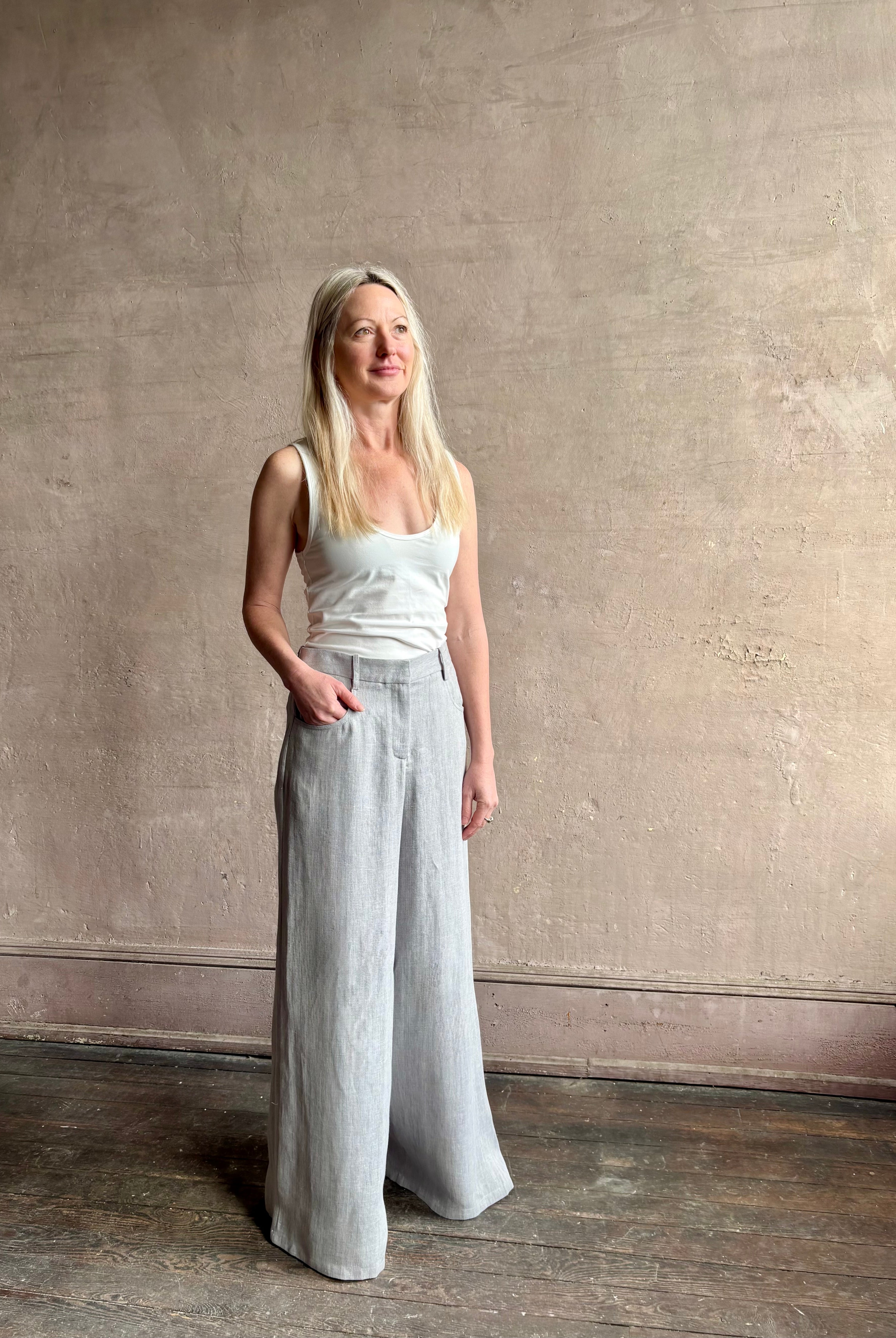 Mature woman wearing the Dillon pant from TWP in an effortlessly sophisticated hemp trouser with an airy wide leg and back pockets