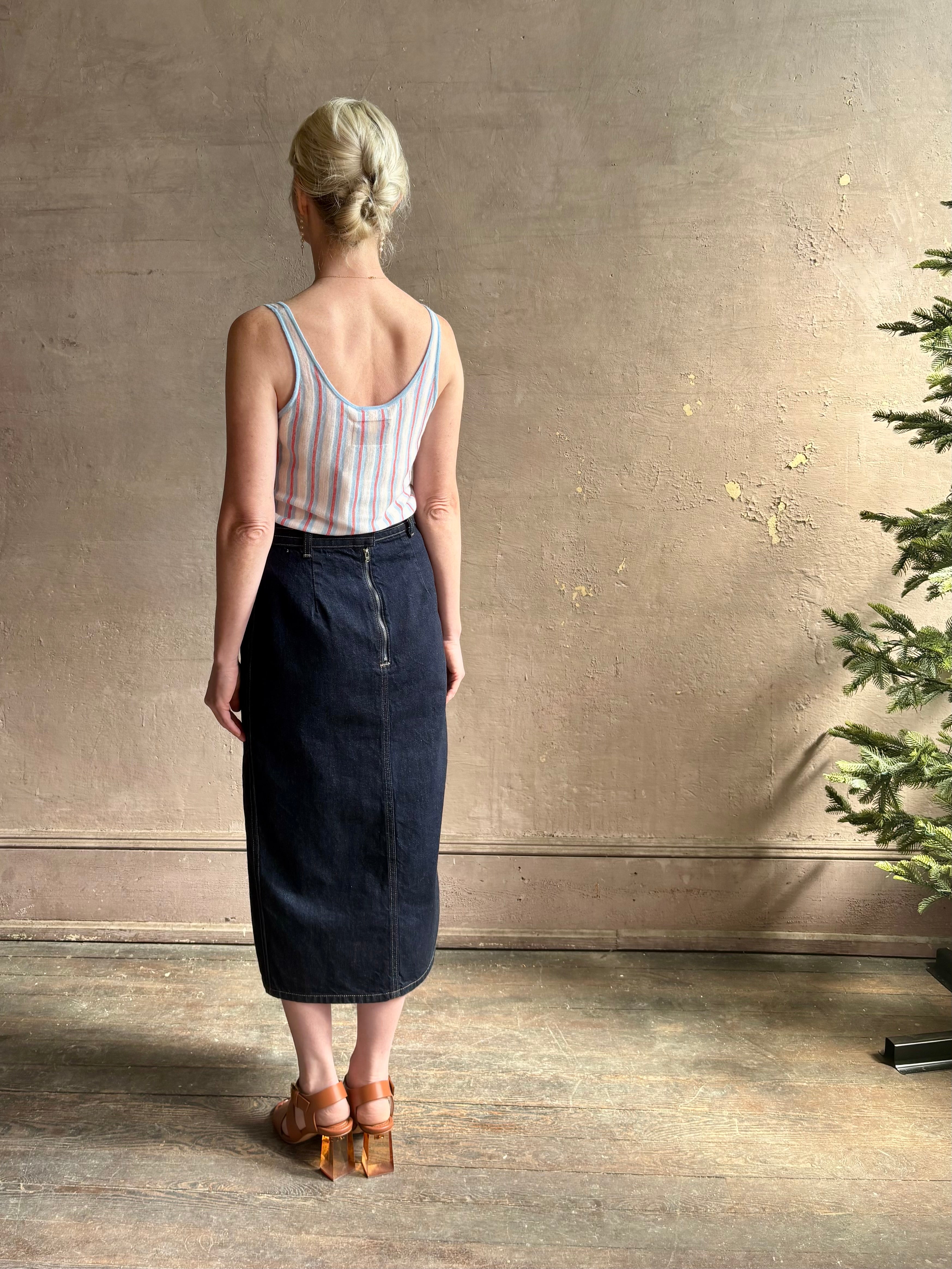 mature woman wearing TWP Premium Cotton American-Made Denim skirt Seams and front vent Dark Stone wash
