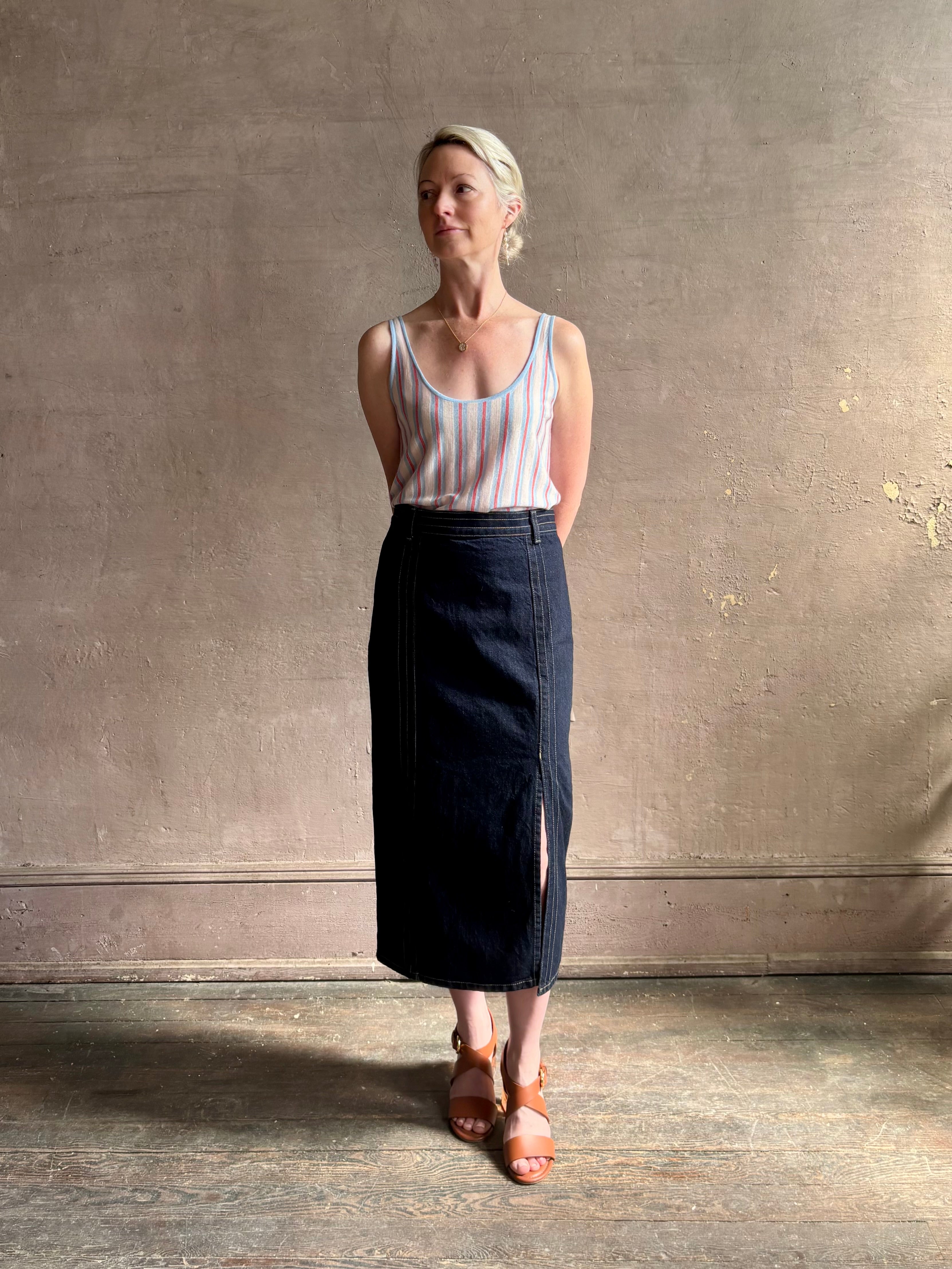 mature woman wearing TWP Premium Cotton American-Made Denim skirt Seams and front vent Dark Stone wash