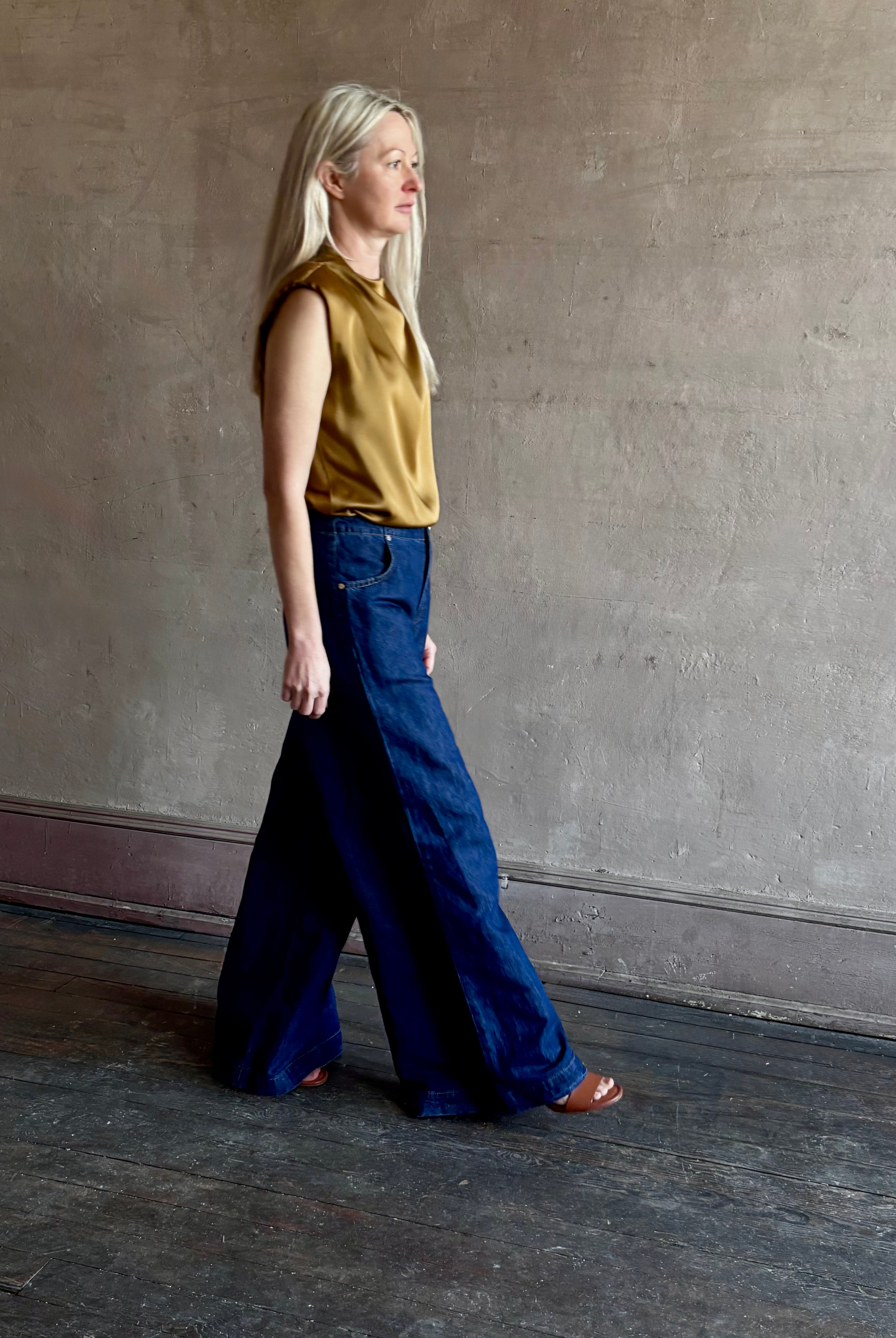 Image of woman wearing designer TWP Dillon cotton linen Denim in Dark Stone wash that is Made in USA with mid-rise and wide leg