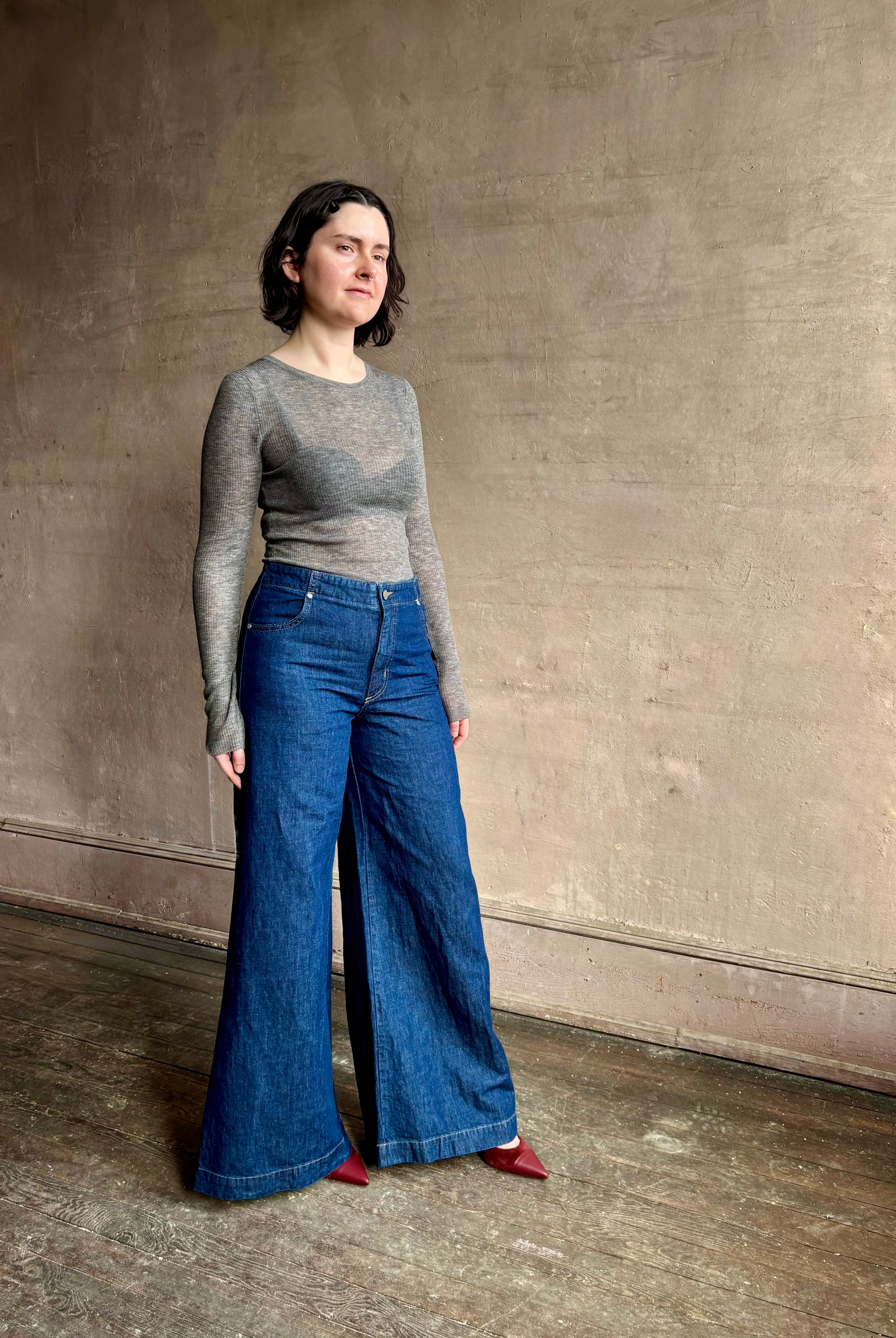 Image of woman wearing designer TWP Dillon cotton linen Denim in Dark Stone wash that is Made in USA with mid-rise and wide leg