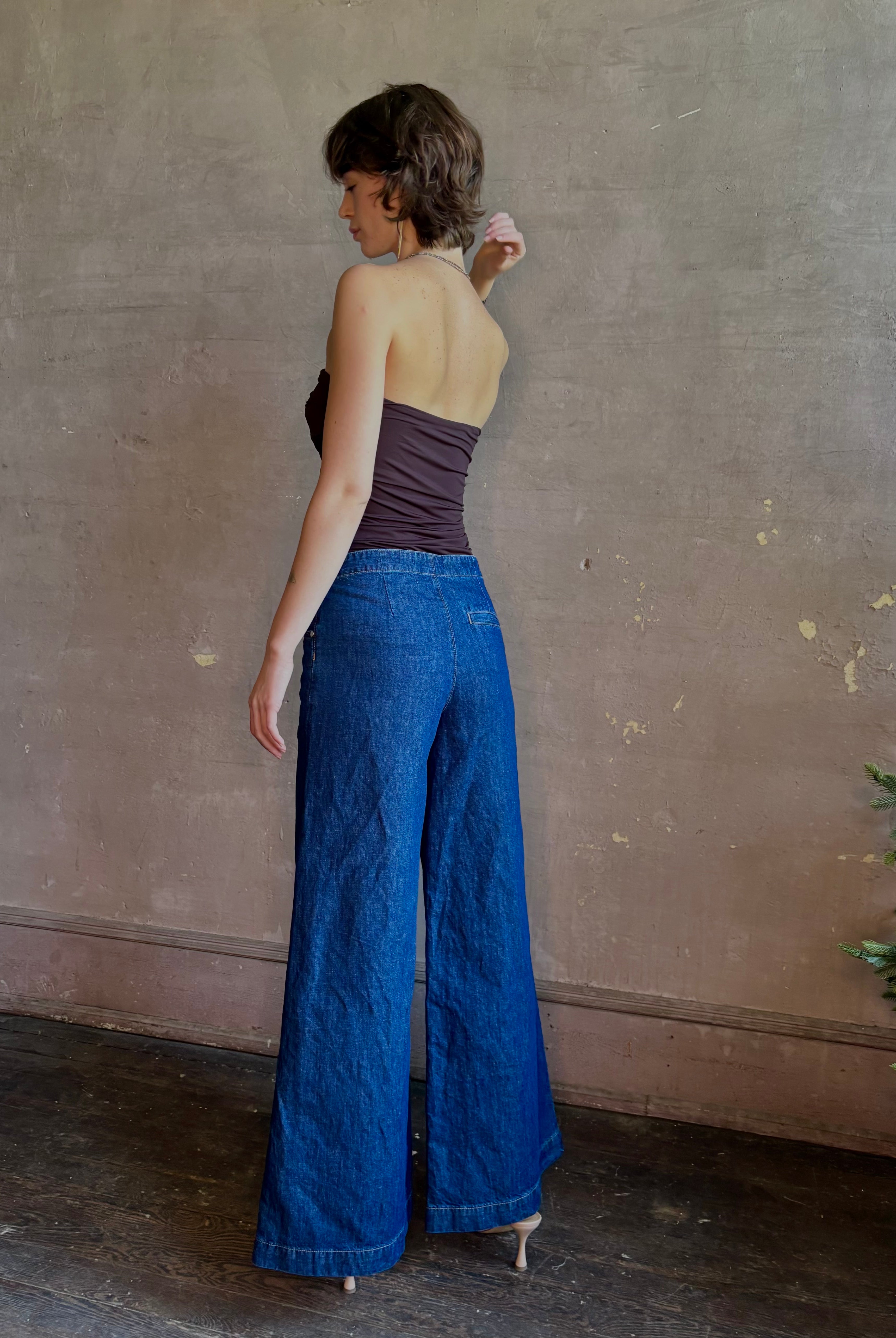 Woman wearing luxury designer TWP Dillon cotton linen Denim in Dark Stone wash that is Made in USA with mid-rise and wide leg
