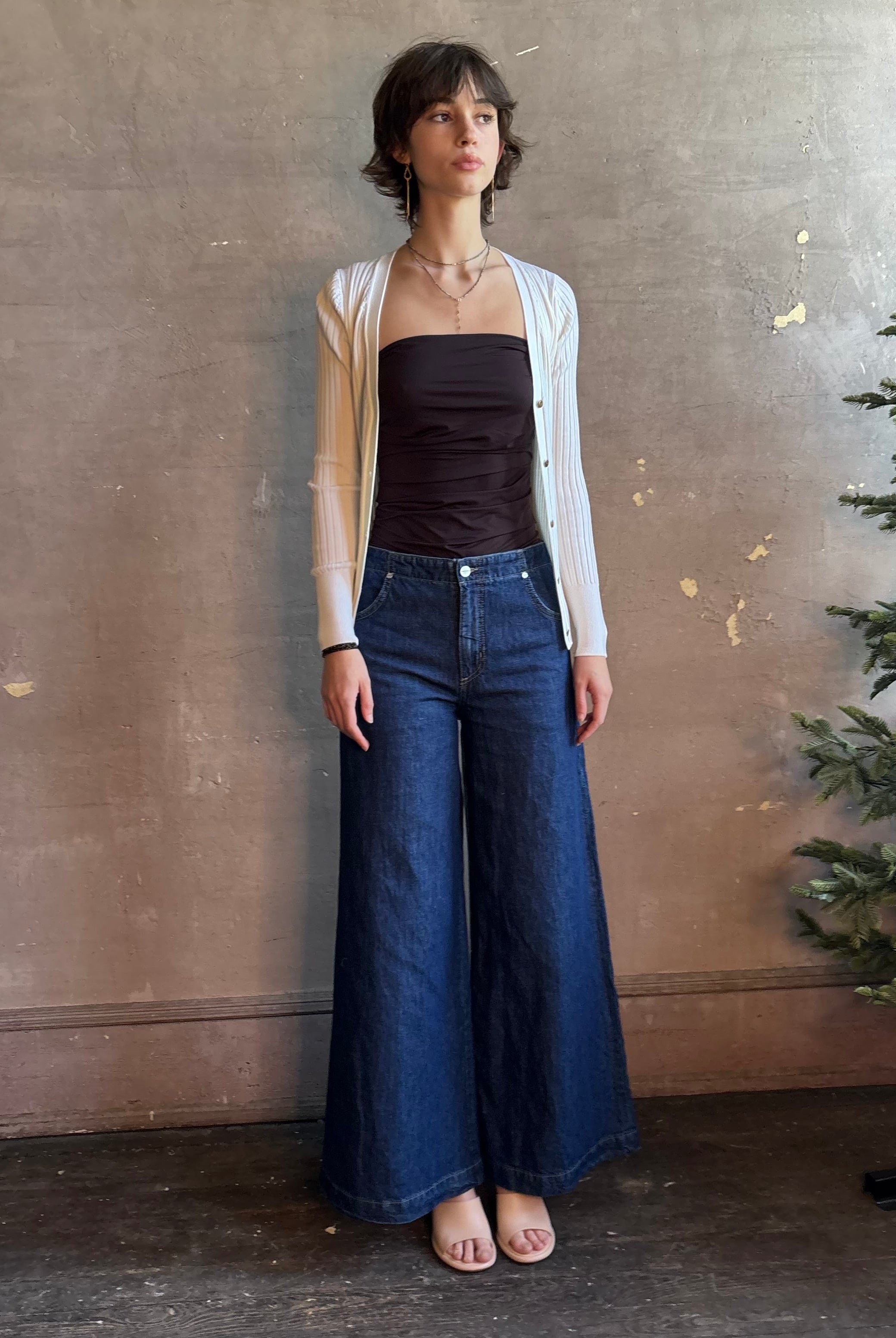 Woman wearing luxury designer TWP Dillon cotton linen Denim in Dark Stone wash that is Made in USA with mid-rise and wide leg