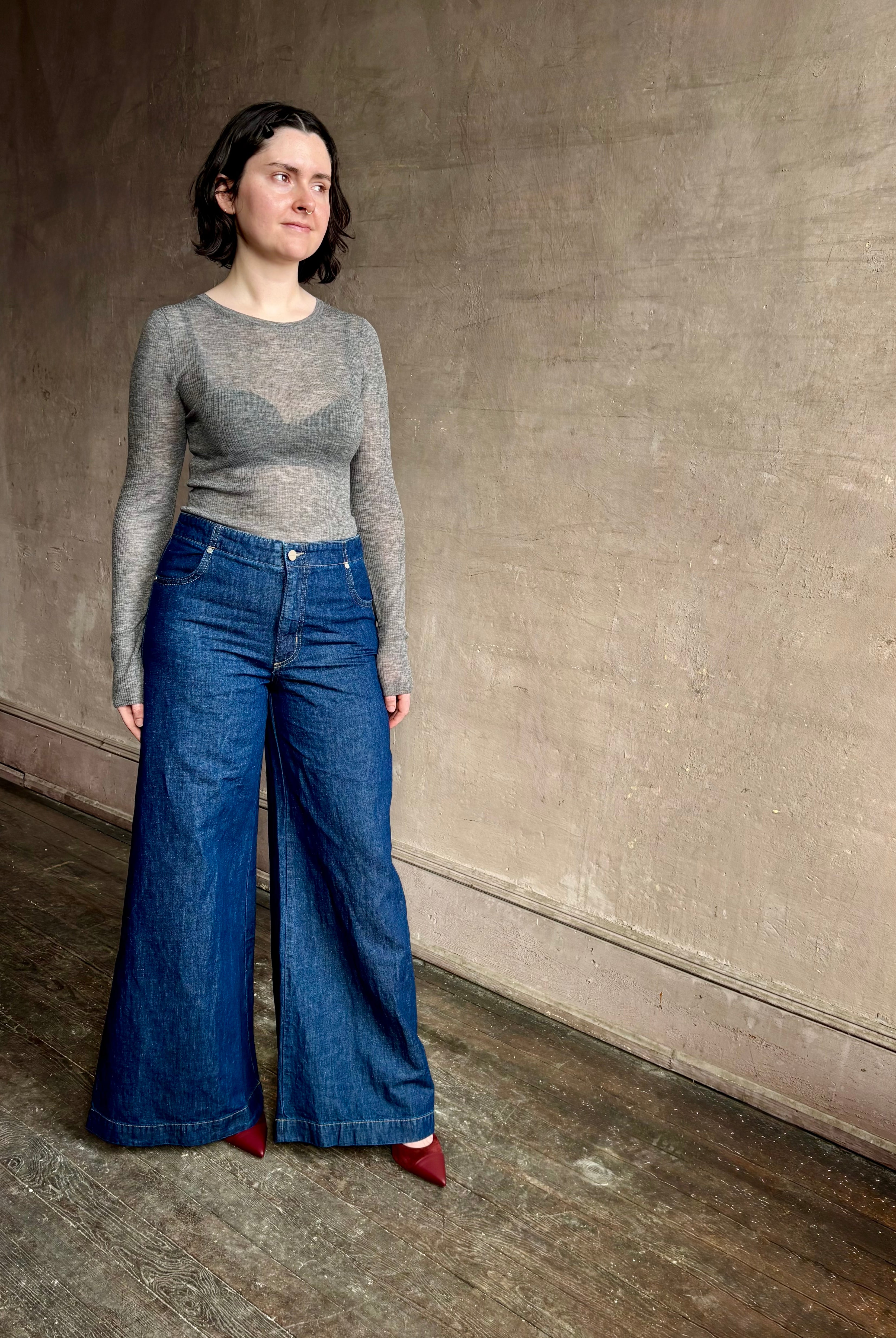 Image of woman wearing designer TWP Dillon cotton linen Denim in Dark Stone wash that is Made in USA with mid-rise and wide leg