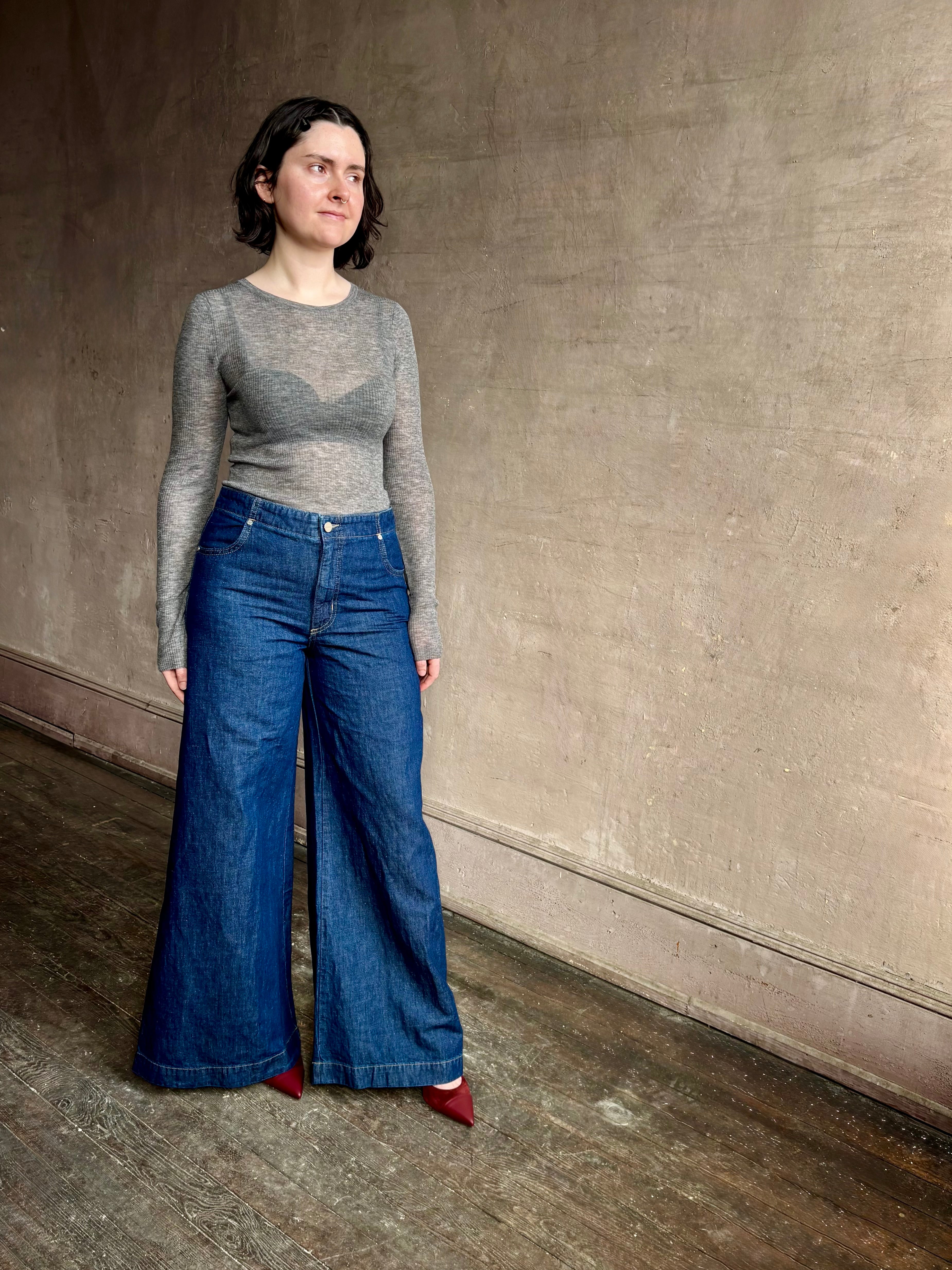 Image of woman wearing designer TWP Dillon cotton linen Denim in Dark Stone wash that is Made in USA with mid-rise and wide leg