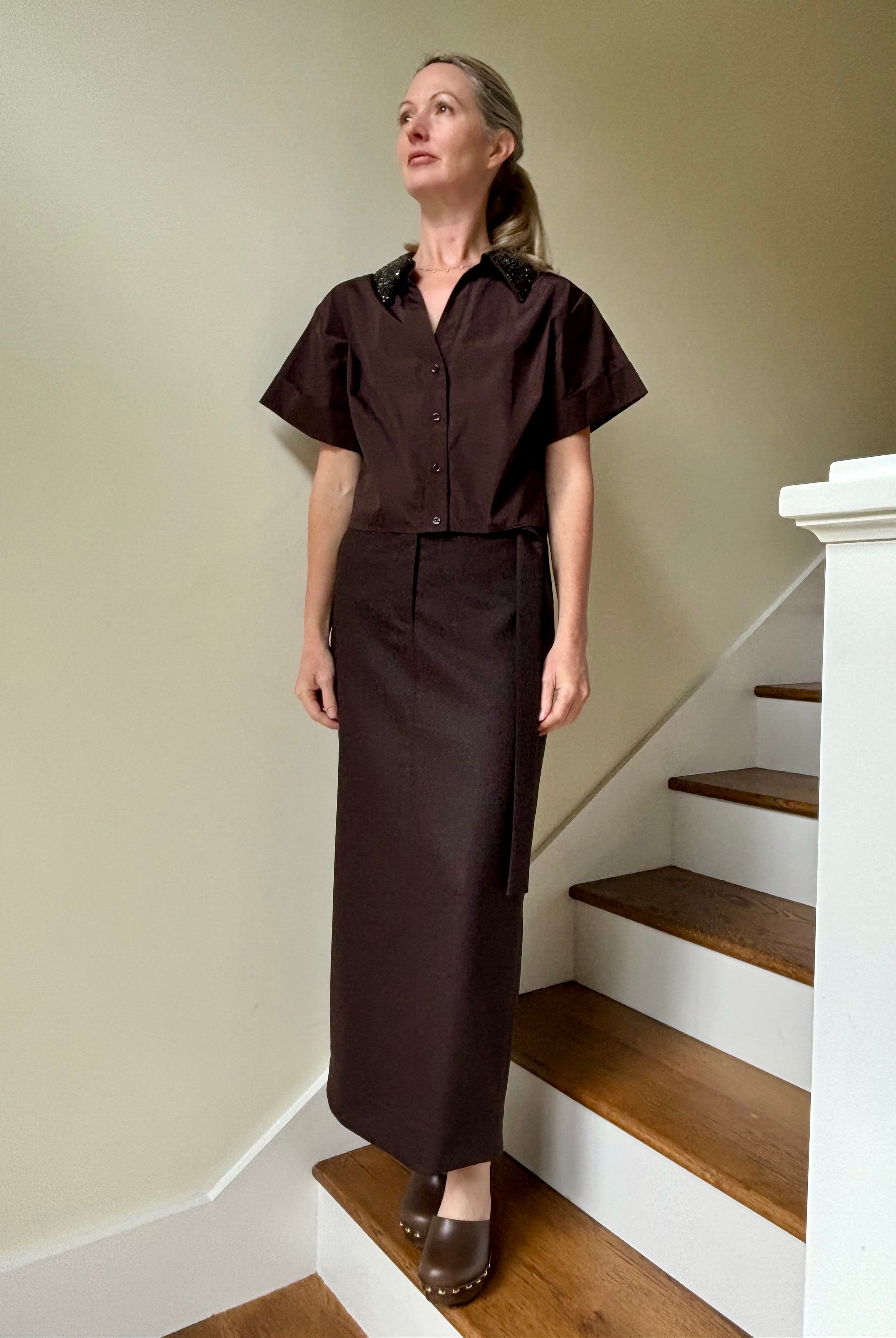 Image of mature woman wearing luxury TWP premium cotton blouse with a crystal collar in a rich chocolate color that's reversible