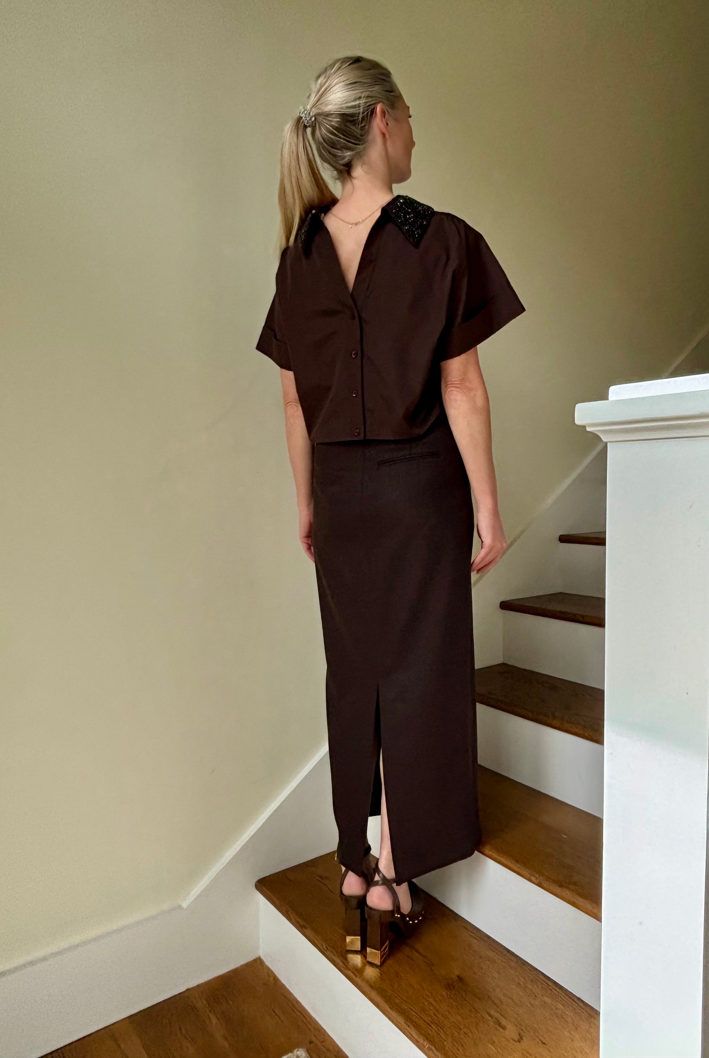 Image of mature woman wearing luxury TWP premium cotton blouse with a crystal collar in a rich chocolate color that's reversible