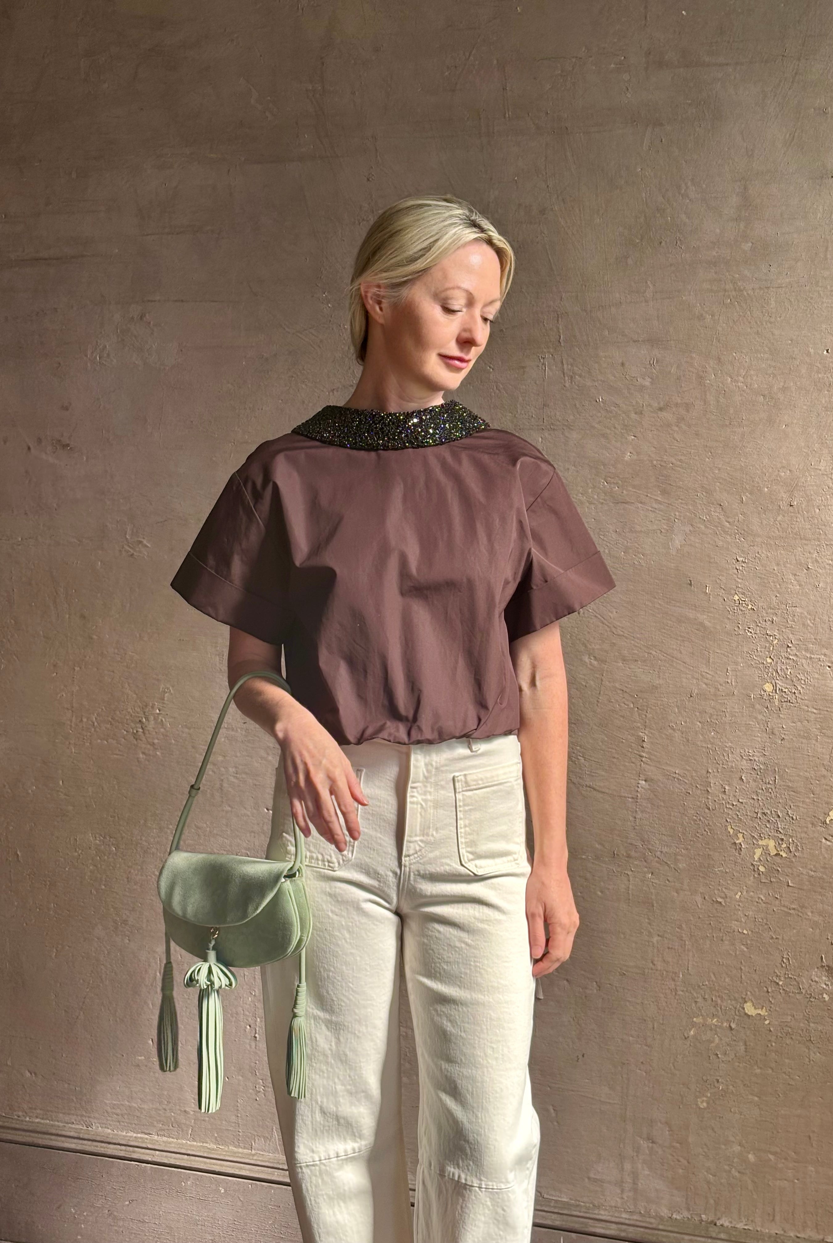 Mature woman wearing Forever and Always with Crystal Collar Top from TWP women's luxury designer blouse rendered in chocolate brown and crafted from 100% cotton in the USA with crystal collar, short sleeves and reversible