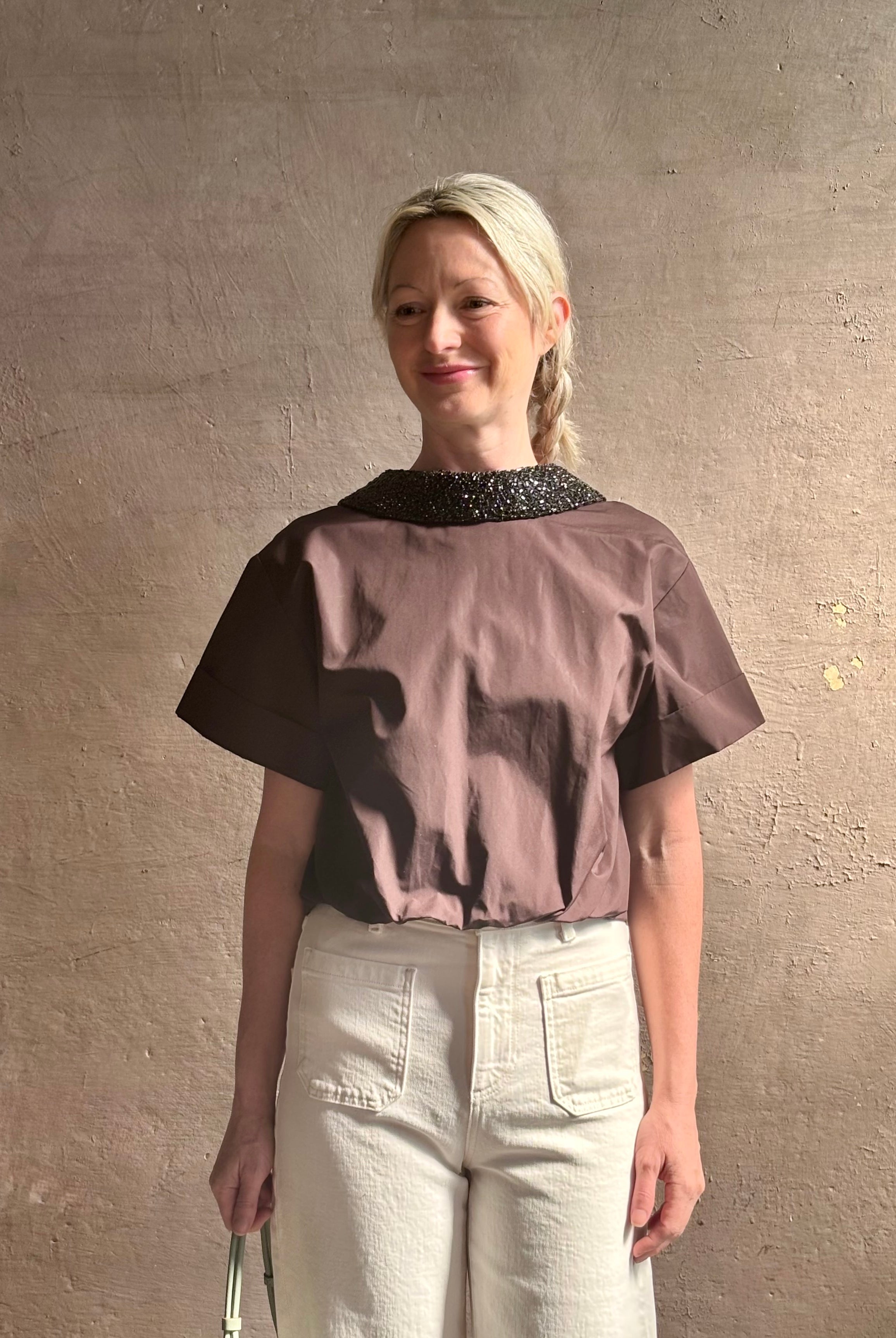 Mature woman wearing Forever and Always with Crystal Collar Top from TWP women's luxury designer blouse rendered in chocolate brown and crafted from 100% cotton in the USA with crystal collar, short sleeves and reversible