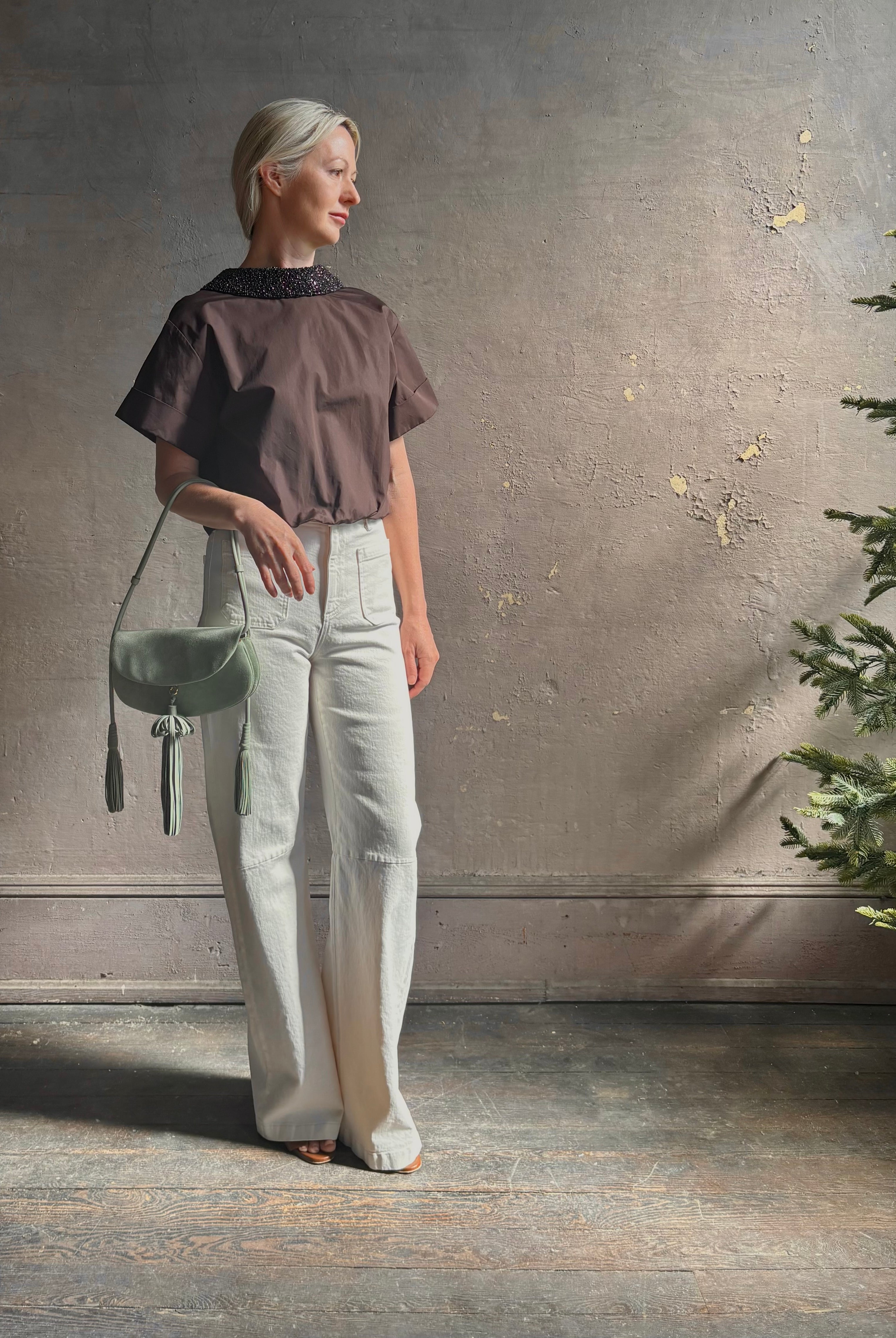 Mature woman wearing Forever and Always with Crystal Collar Top from TWP women's luxury designer blouse rendered in chocolate brown and crafted from 100% cotton in the USA with crystal collar, short sleeves and reversible