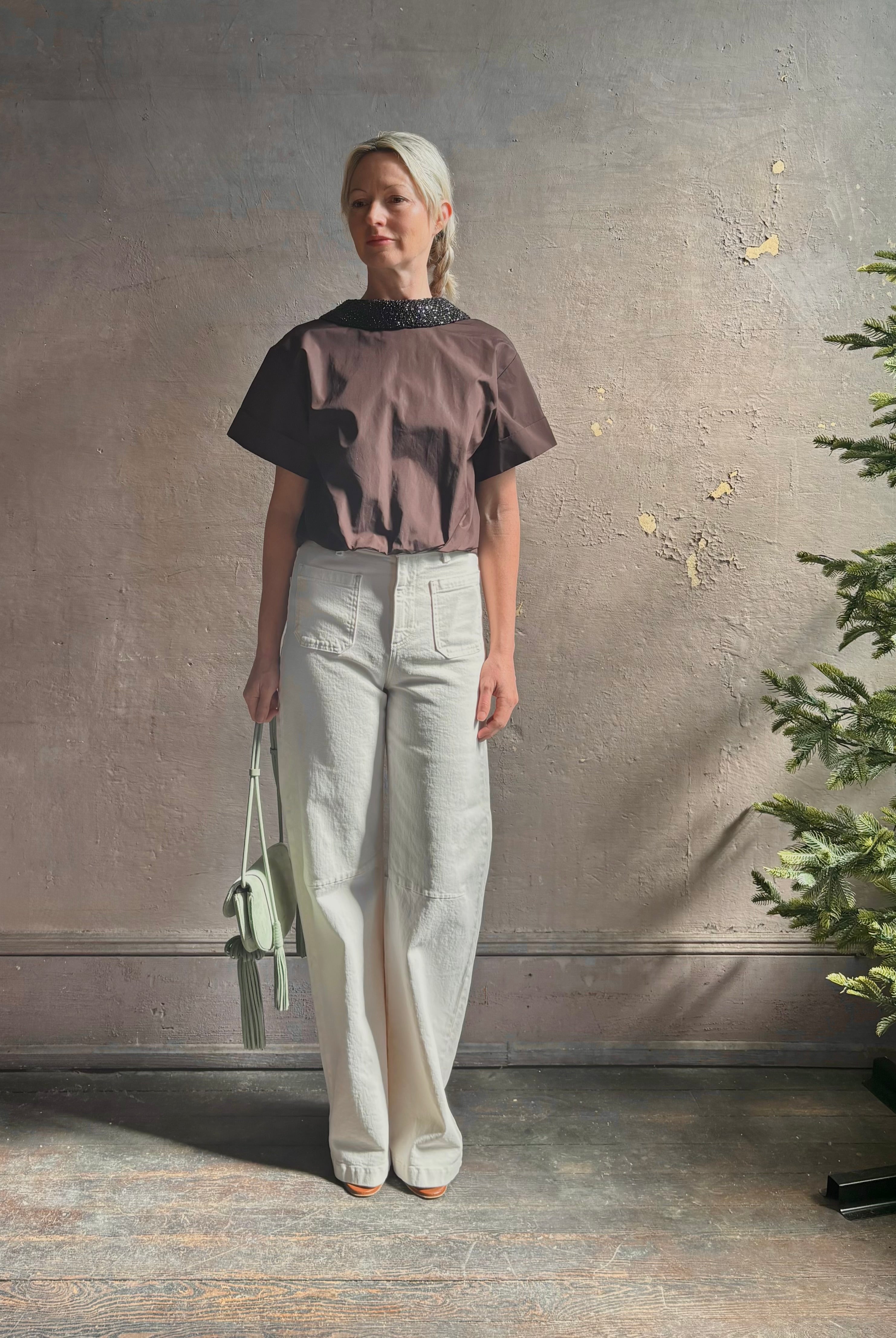 Mature woman wearing Forever and Always with Crystal Collar Top from TWP women's luxury designer blouse rendered in chocolate brown and crafted from 100% cotton in the USA with crystal collar, short sleeves and reversible