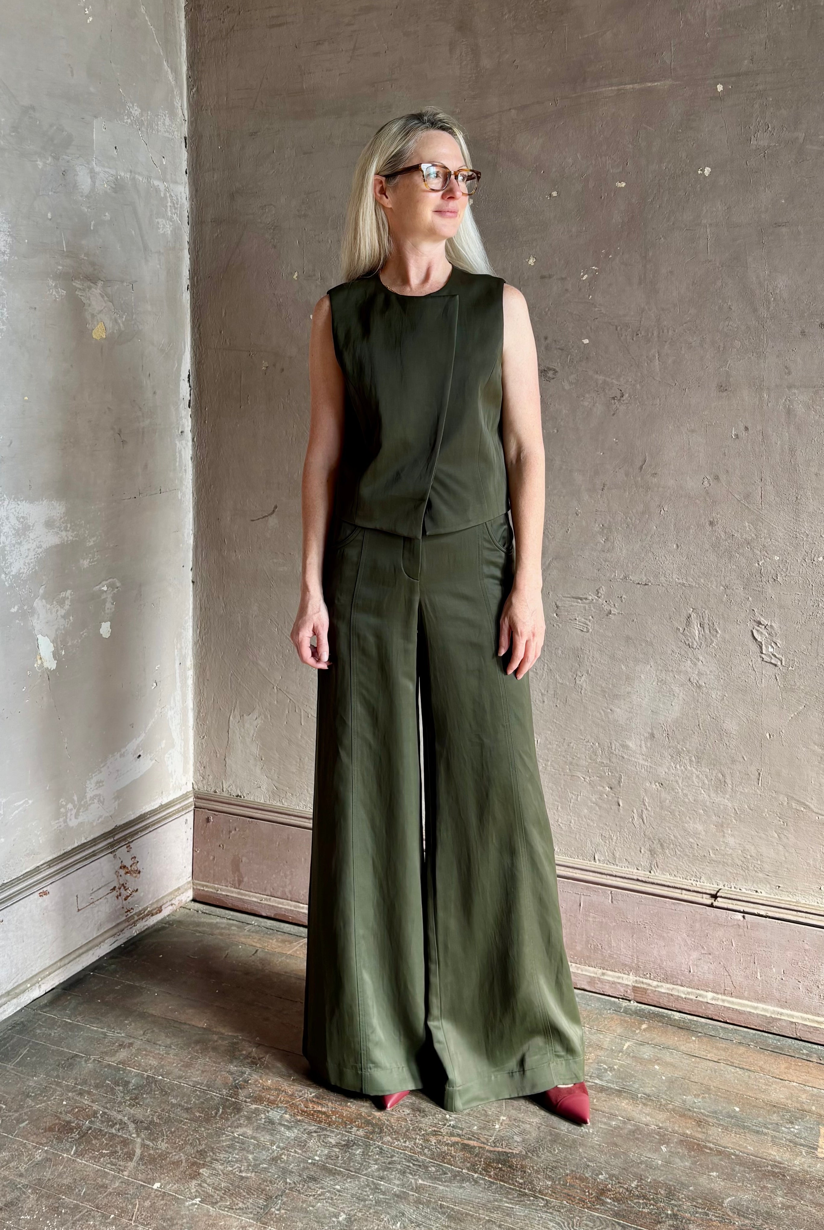 Luxury women's clothing brand TWP high neck hidden placket vest top with matching pant set in a green linen blend