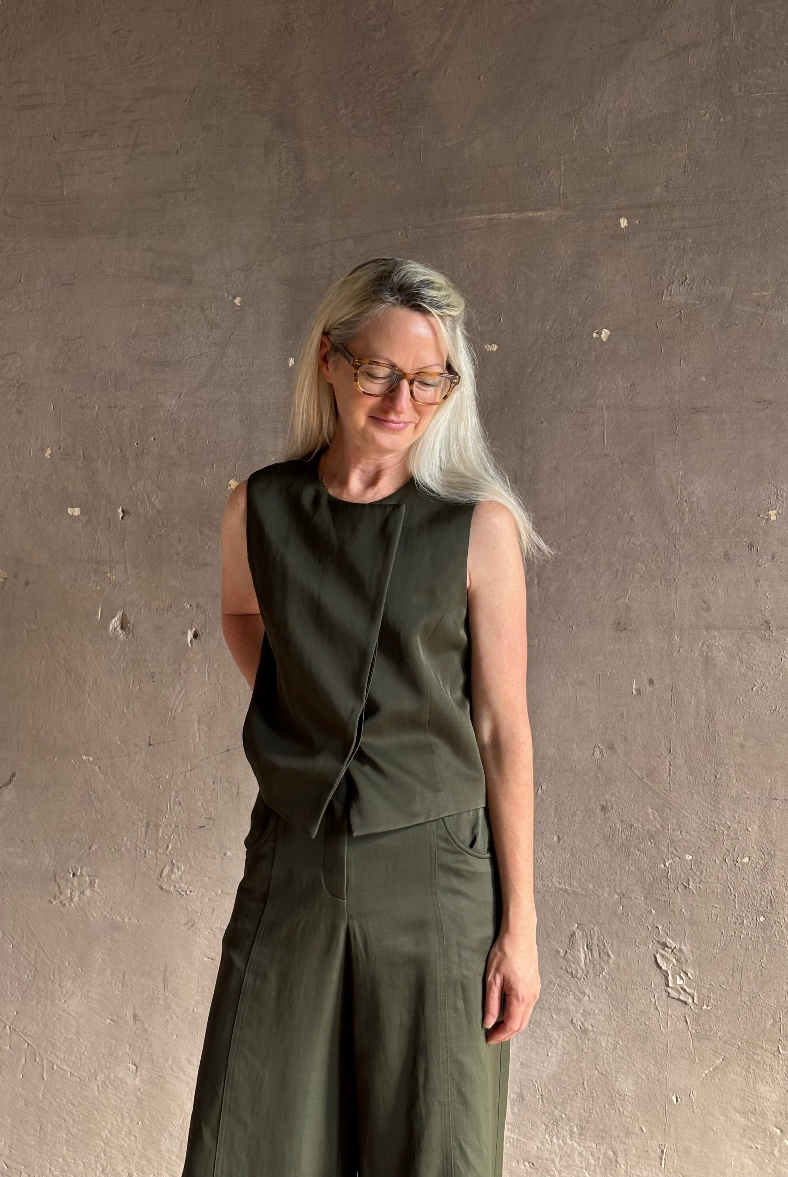 Luxury women's clothing brand TWP high neck hidden placket vest top with matching pant set in a green linen blend