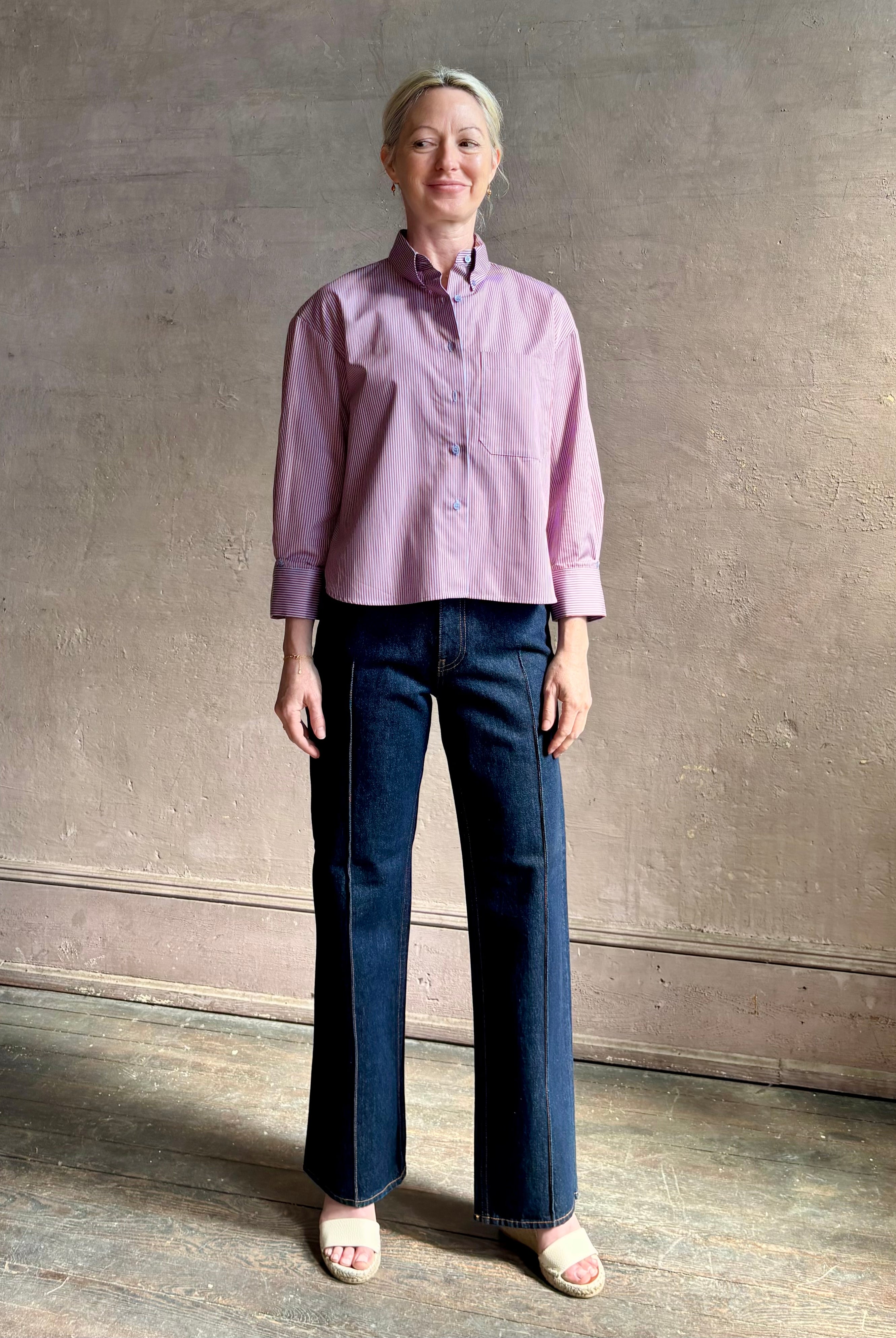 Woman wearing premium cotton poplin JD menswear inspired shirt from TWP rust and blue stripe with long sleeve