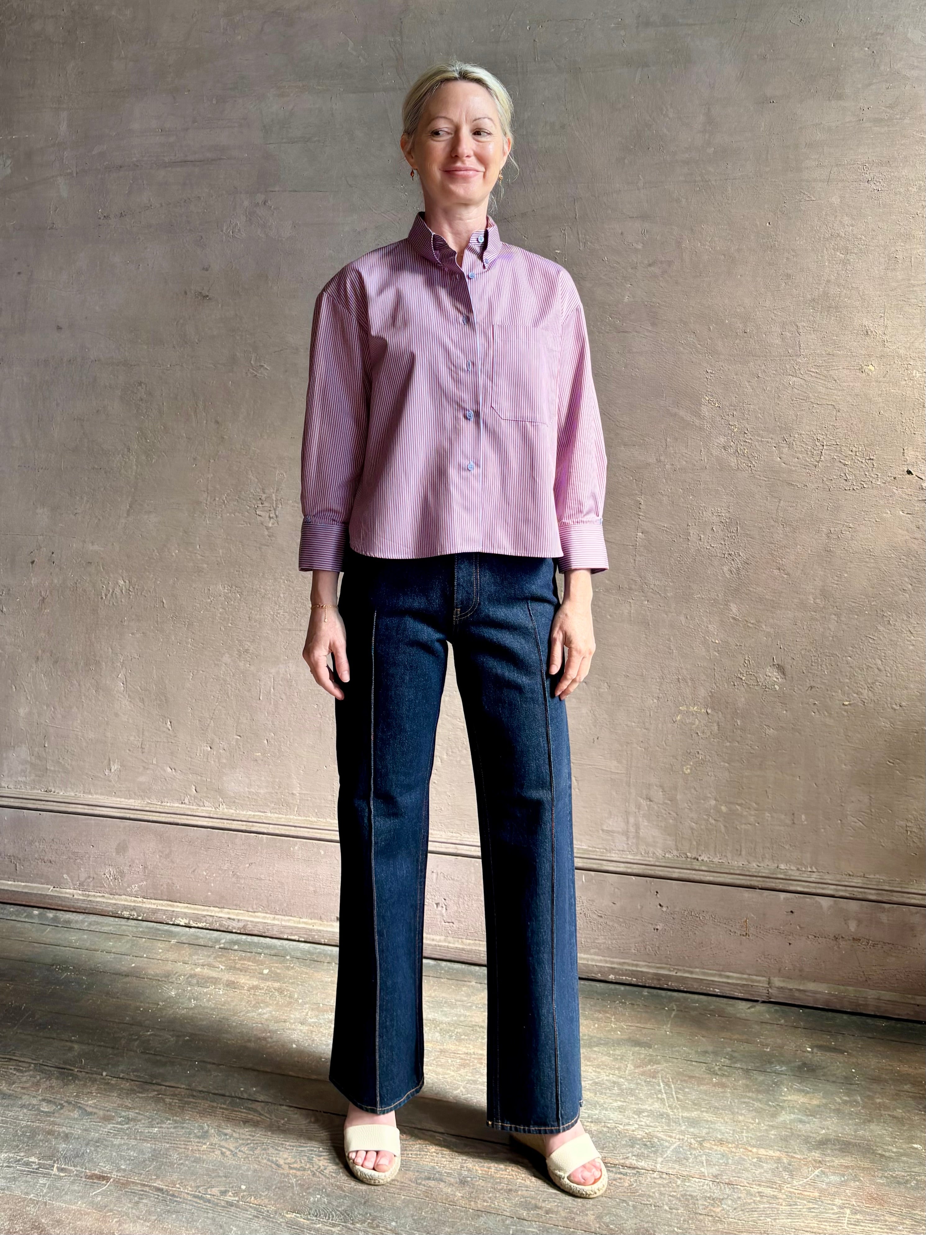 Woman wearing premium cotton poplin JD menswear inspired shirt from TWP rust and blue stripe with long sleeve