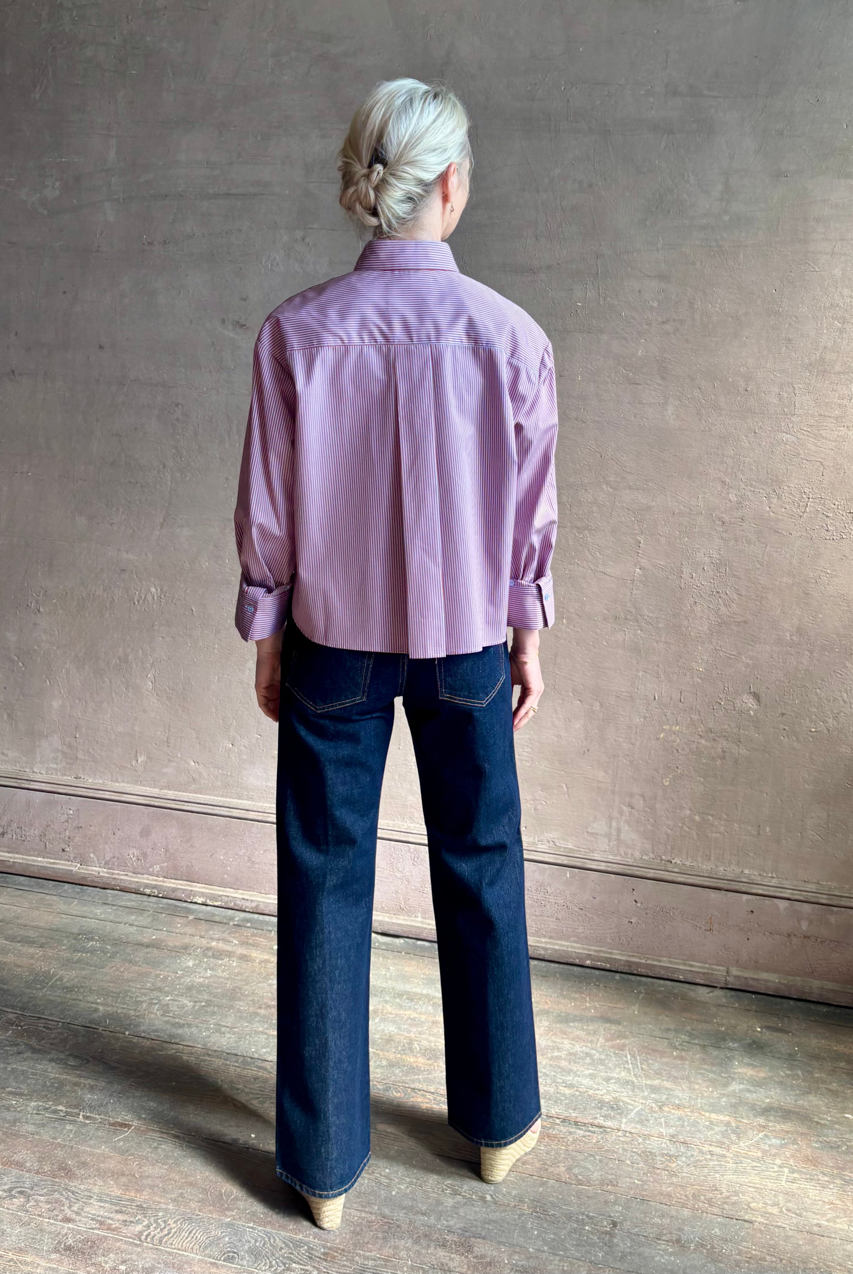 Woman wearing premium cotton poplin JD menswear inspired shirt from TWP rust and blue stripe with long sleeve