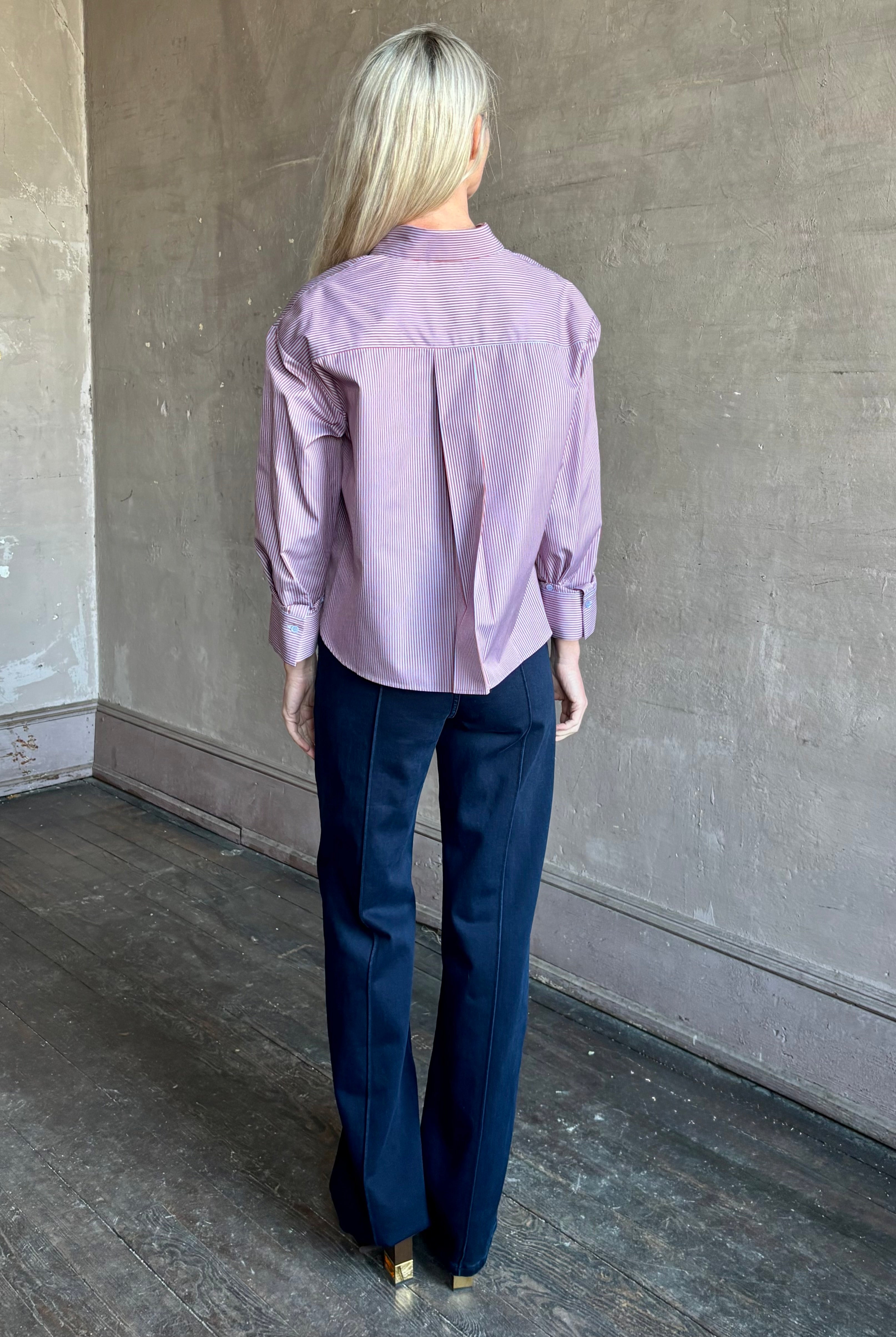 Woman wearing premium cotton poplin JD menswear inspired shirt from TWP in a rust and blue stripe with long sleeve and collar