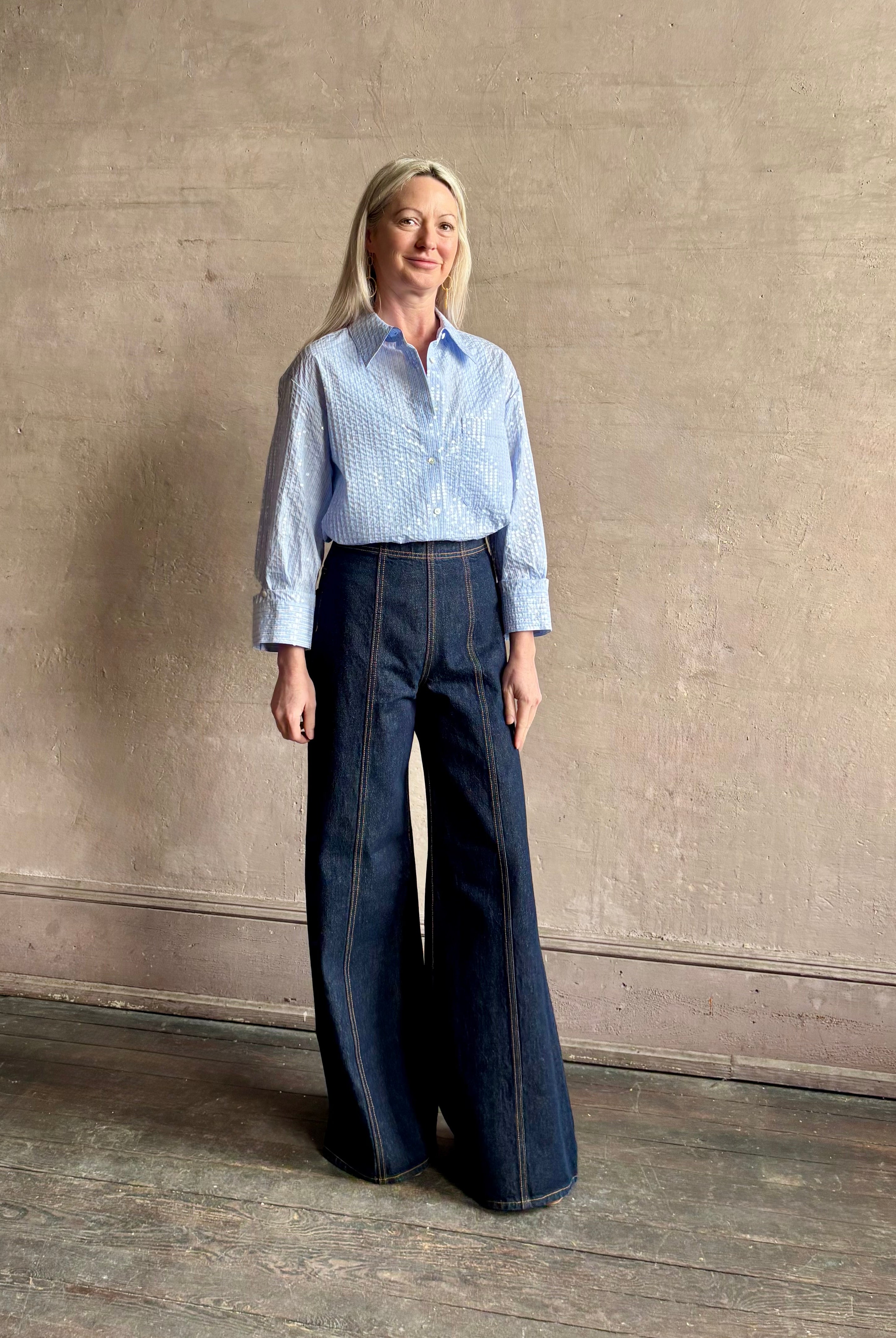 Mature woman wearing JD blue and white stripe collared button-down shirt by TWP with sequin embellishments
