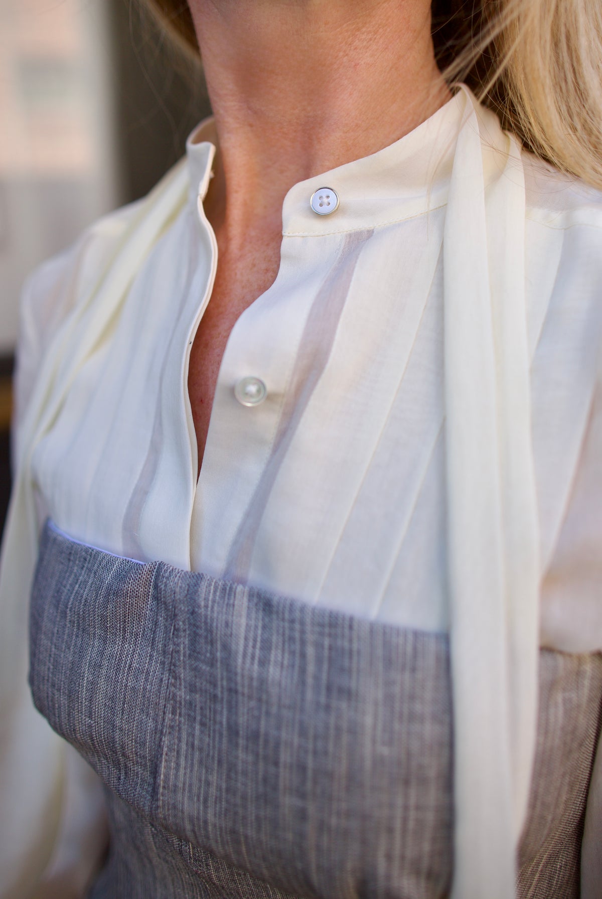 Mature woman wearing luxury brand TWP Jillian cotton-wool bustier in heather grey with bust darts and zip closure perfect for elevated layering