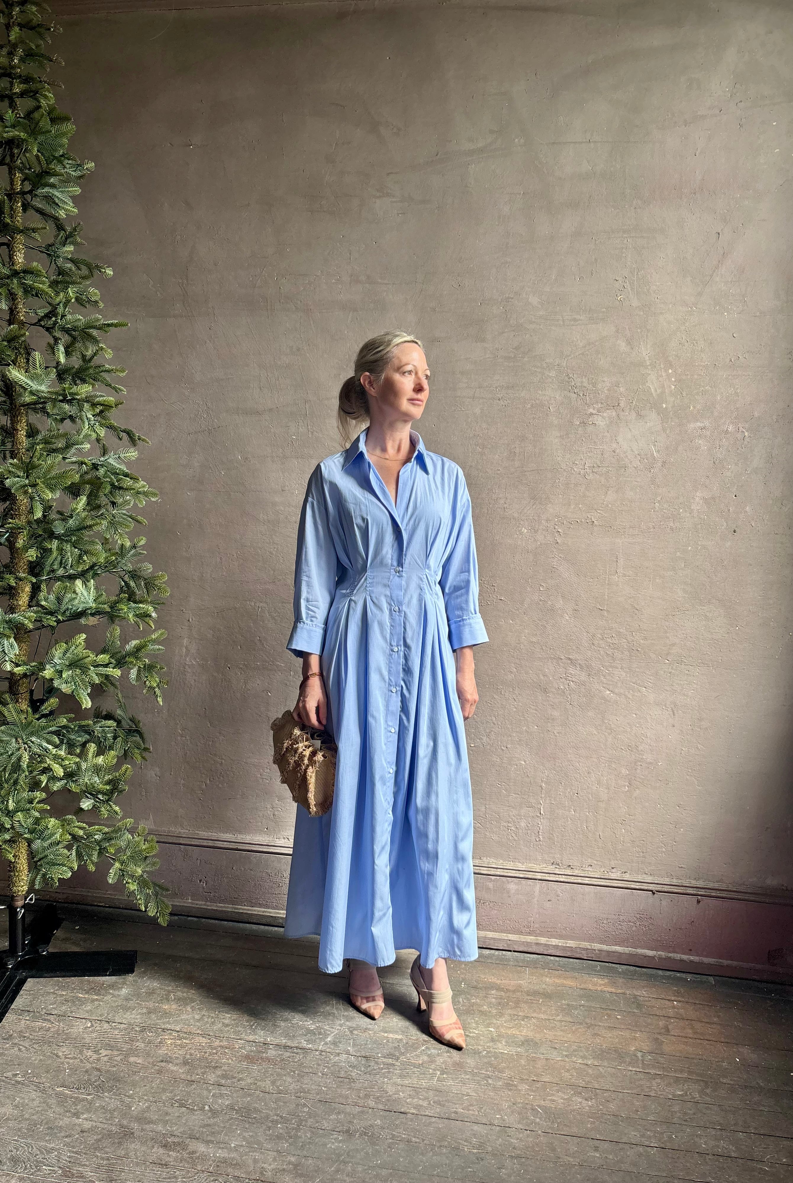Mature woman wearing TWP M Dress, luxury women's superfine cotton dress button-front closure with pleats blue