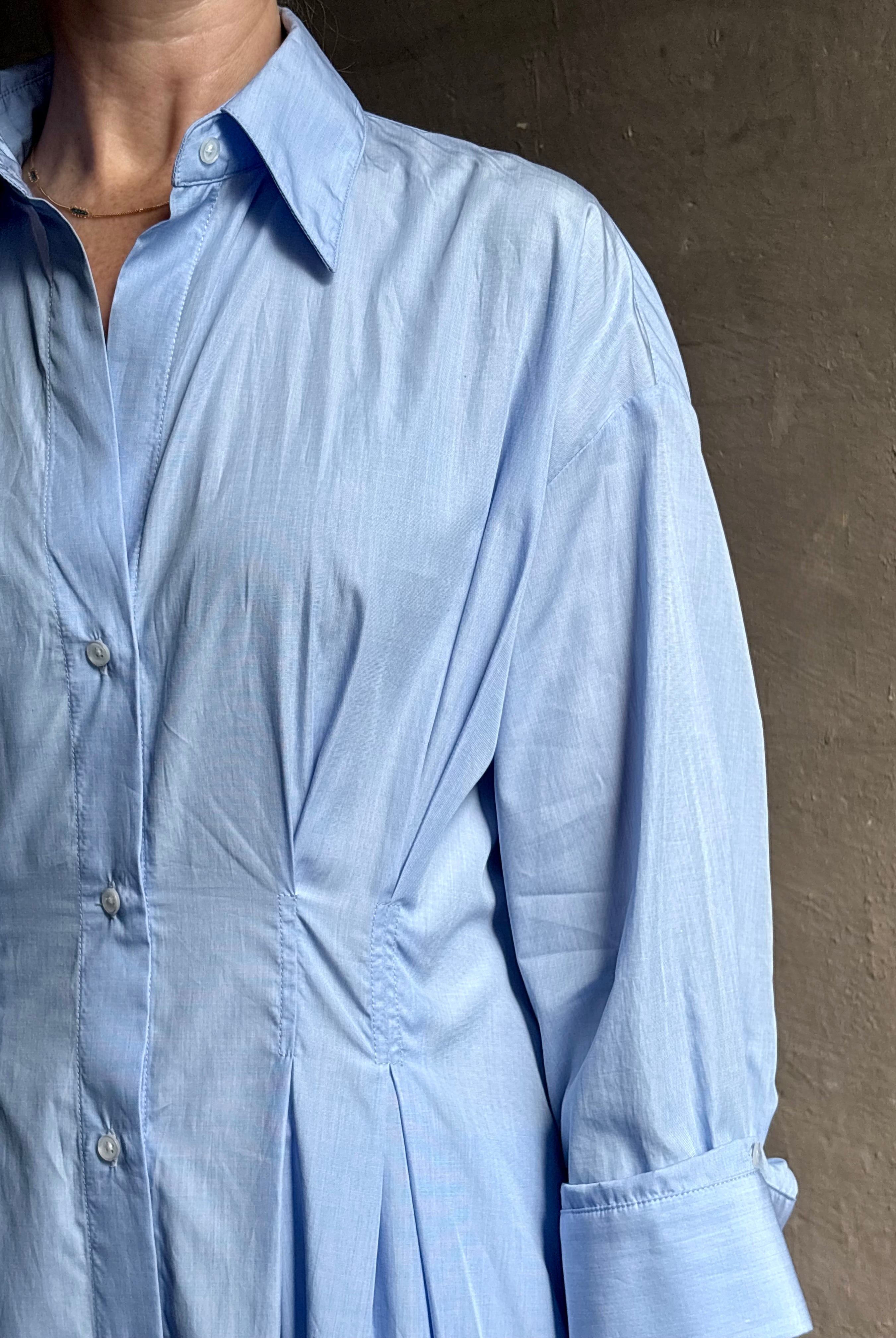 Mature woman wearing TWP M Dress, luxury women's superfine cotton dress button-front closure with pleats blue