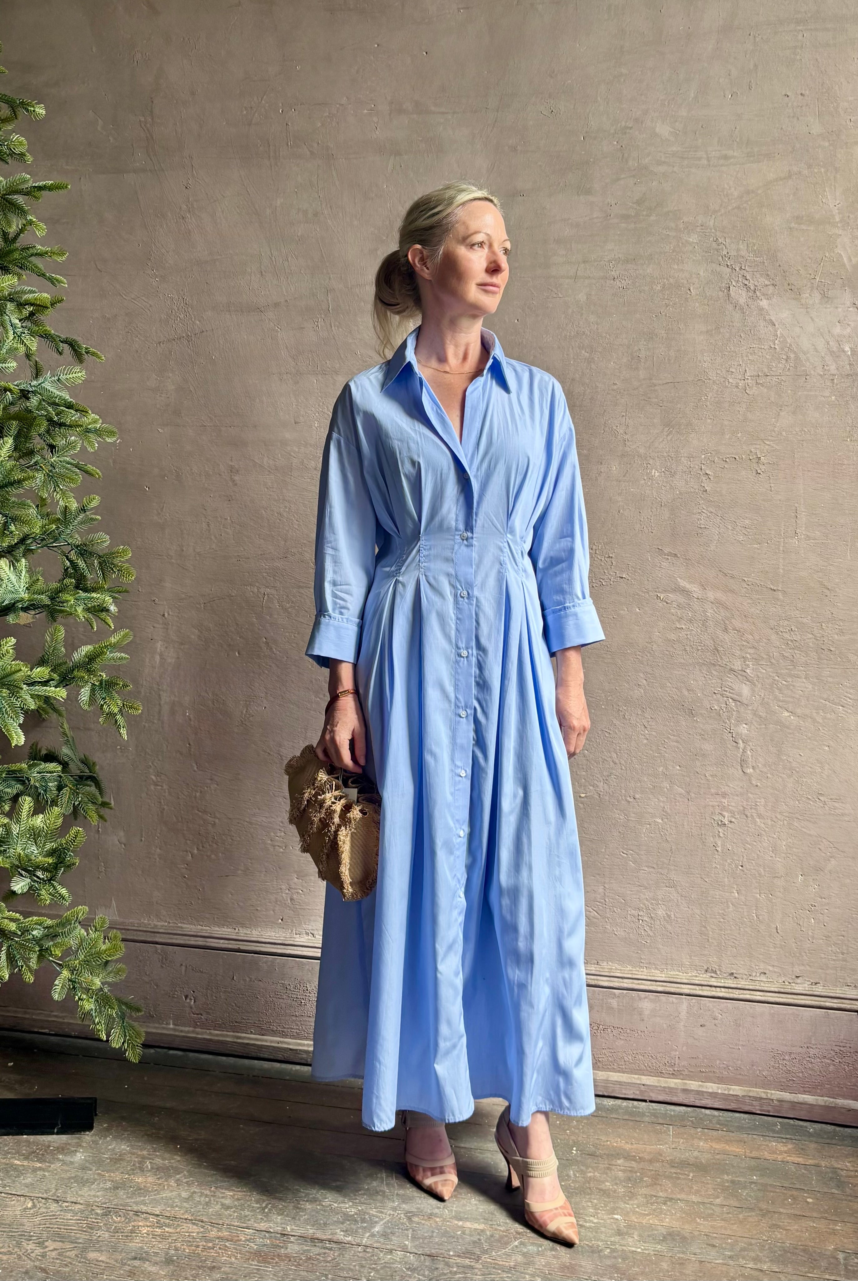 Mature woman wearing TWP M Dress, luxury women's superfine cotton dress button-front closure with pleats blue