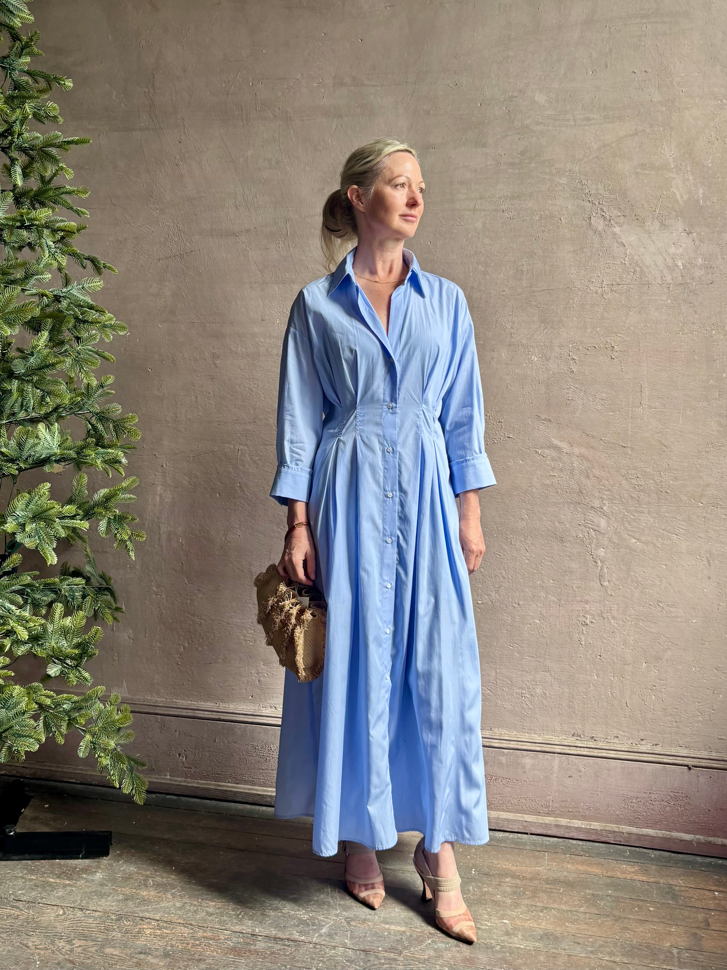 Mature woman wearing TWP M Dress, luxury women's superfine cotton dress button-front closure with pleats blue