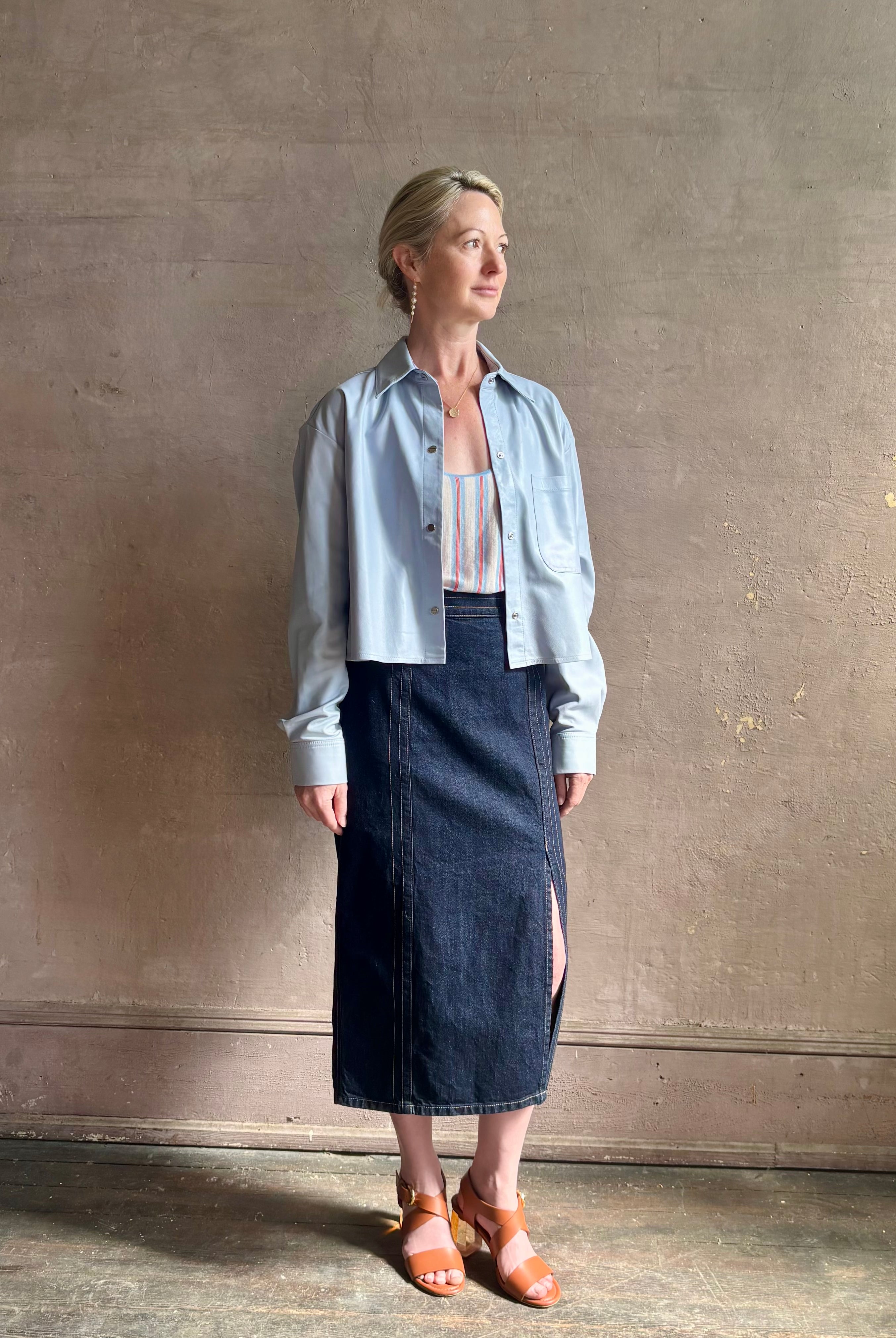 Mature woman reviewing premium lambskin leather TWP Little Big Joe button down cropped Shirt or Jacket in Kentucky Blue with long sleeves
