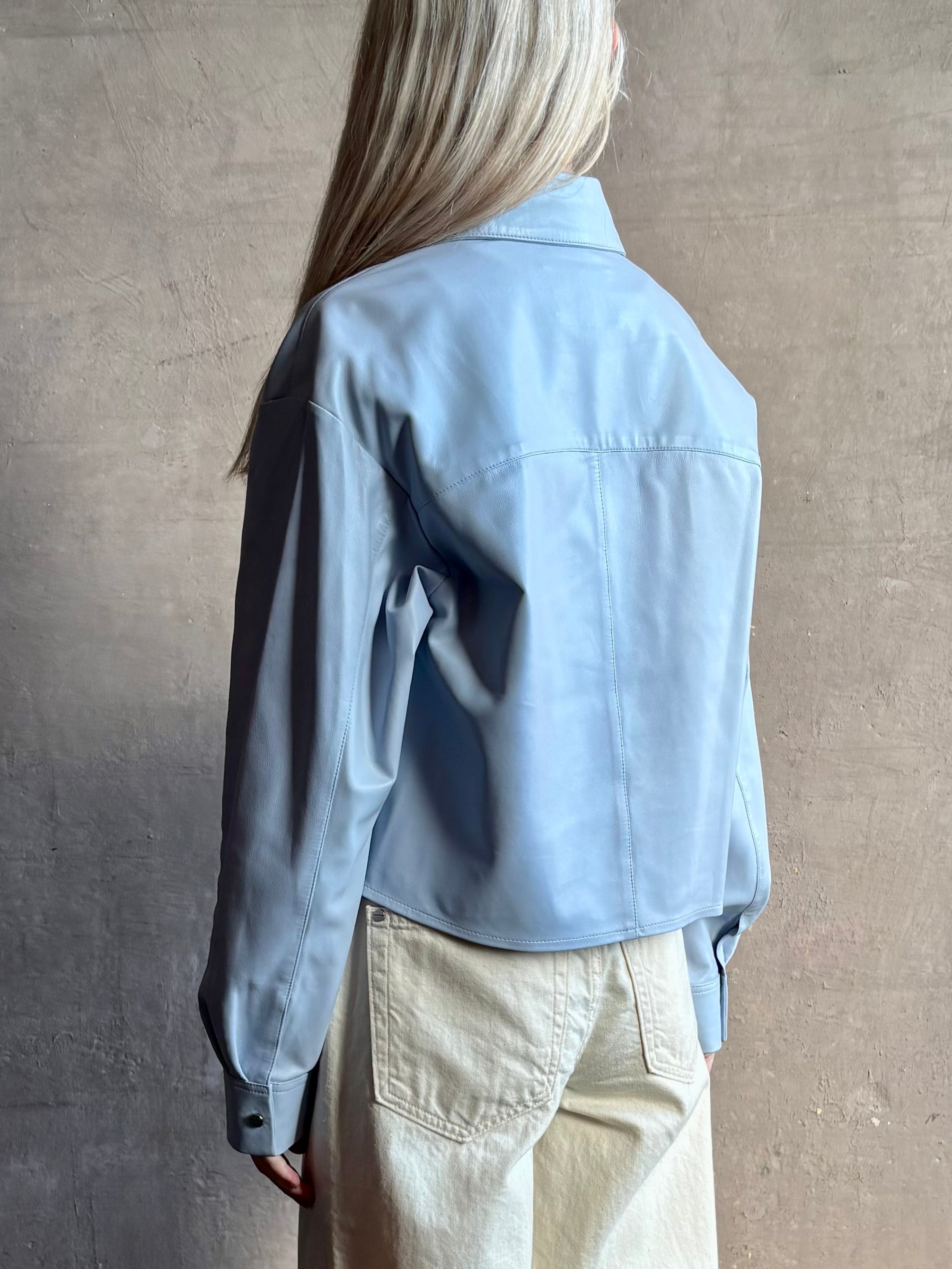 Image of woman wearing premium lambskin leather TWP Little Big Joe button down cropped Shirt in Kentucky Blue