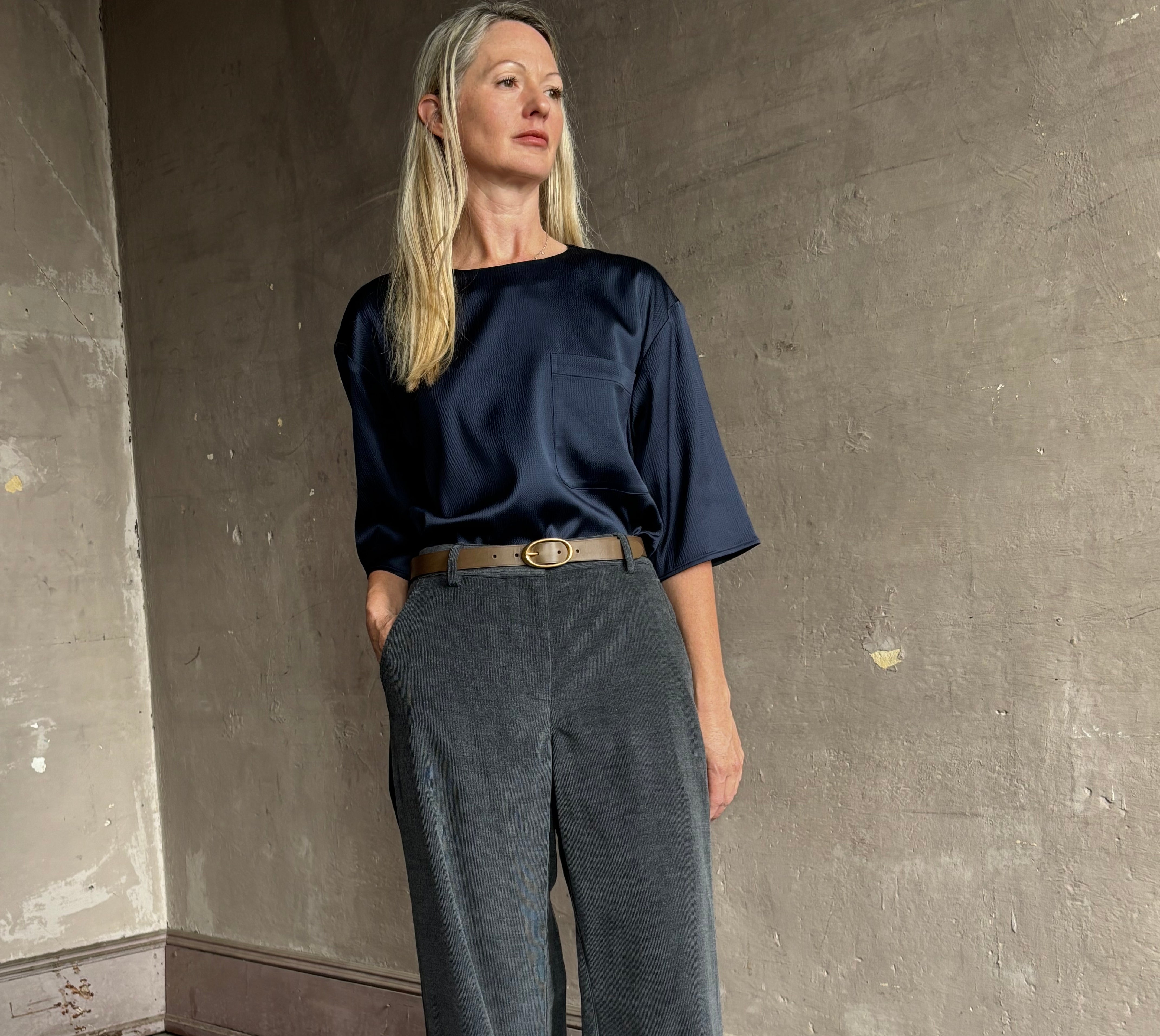 image of mature woman wearing TWP narrow belt in mink  fabricated with premium leather and brass oval buckle
