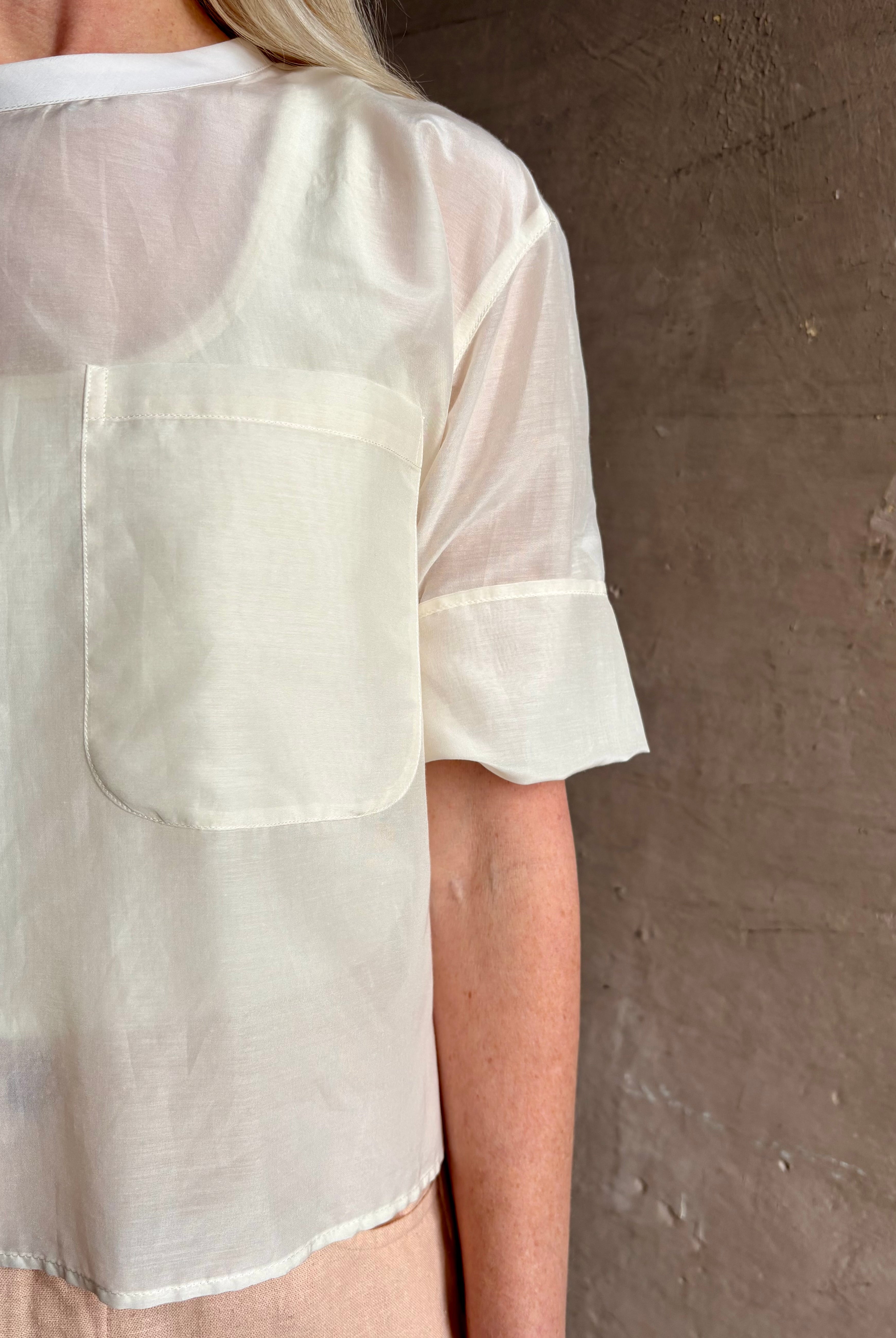Mature woman wearing TWP New Ex T top in an Ivory lightweight cotton silk blend with short sleeves crew neck