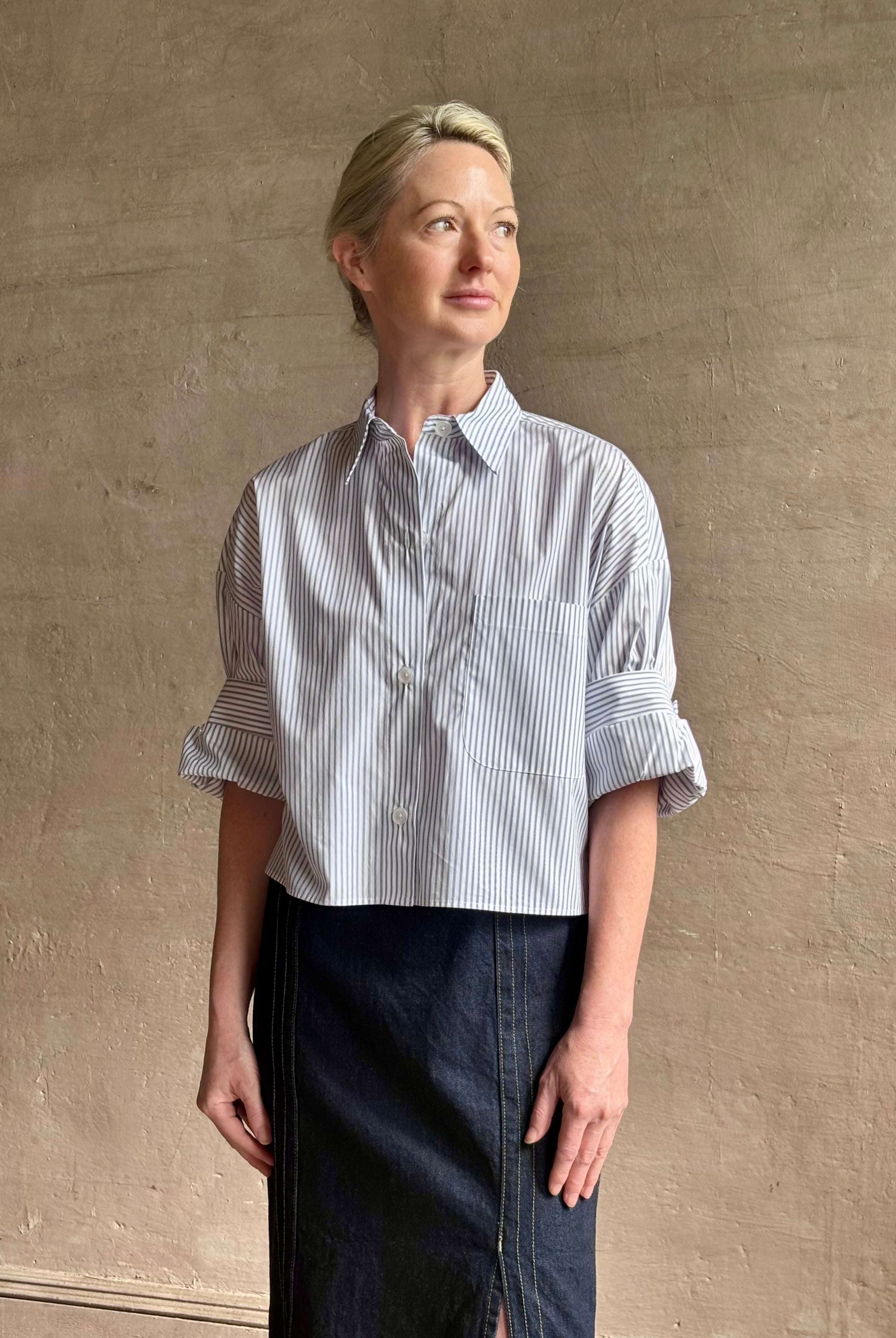 Woman wearing luxury cotton poplin TWP Next EX Shirt White and navy stripe with collar button front made in USA