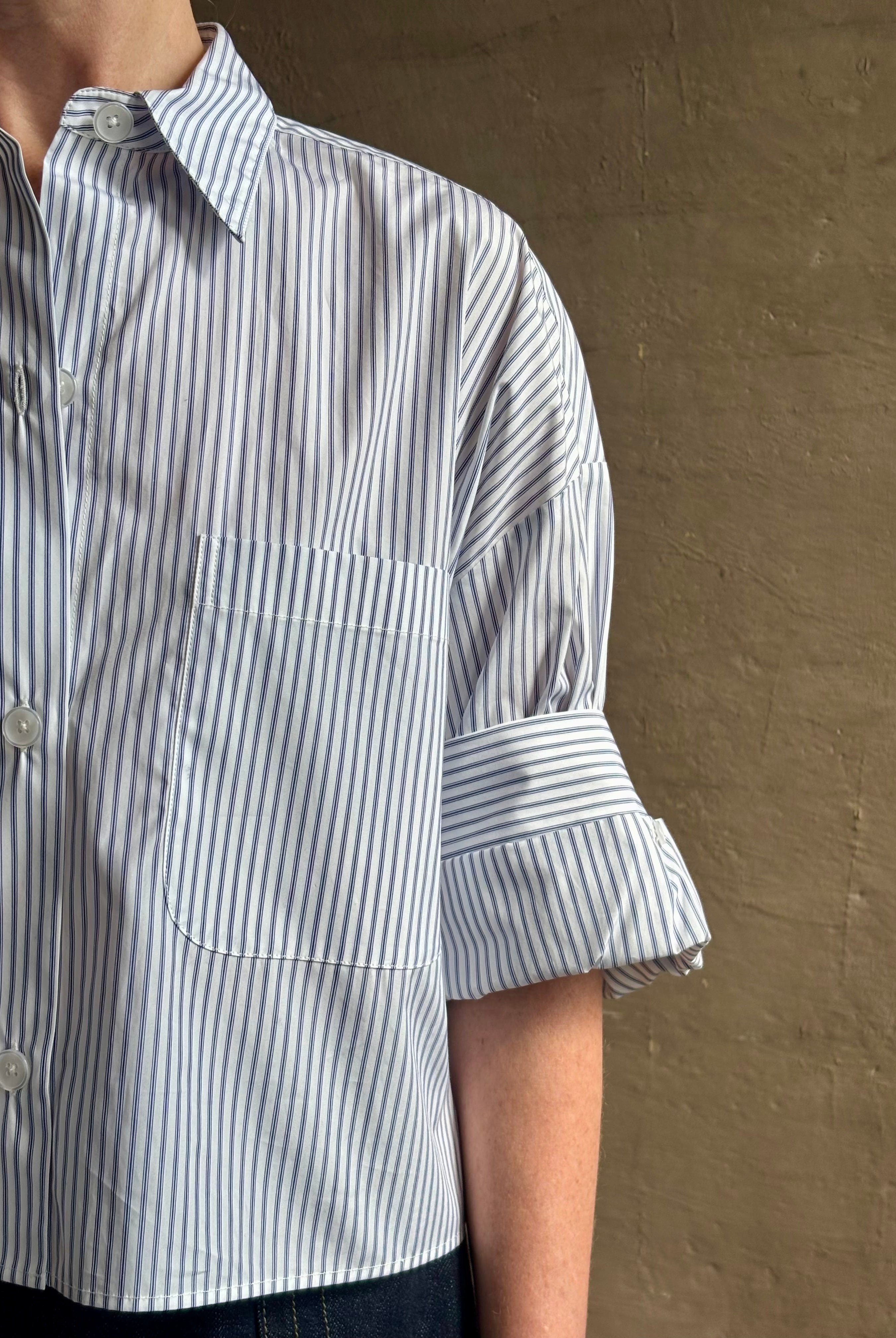 Woman wearing luxury cotton poplin TWP Next EX Shirt White and navy stripe with collar button front made in USA