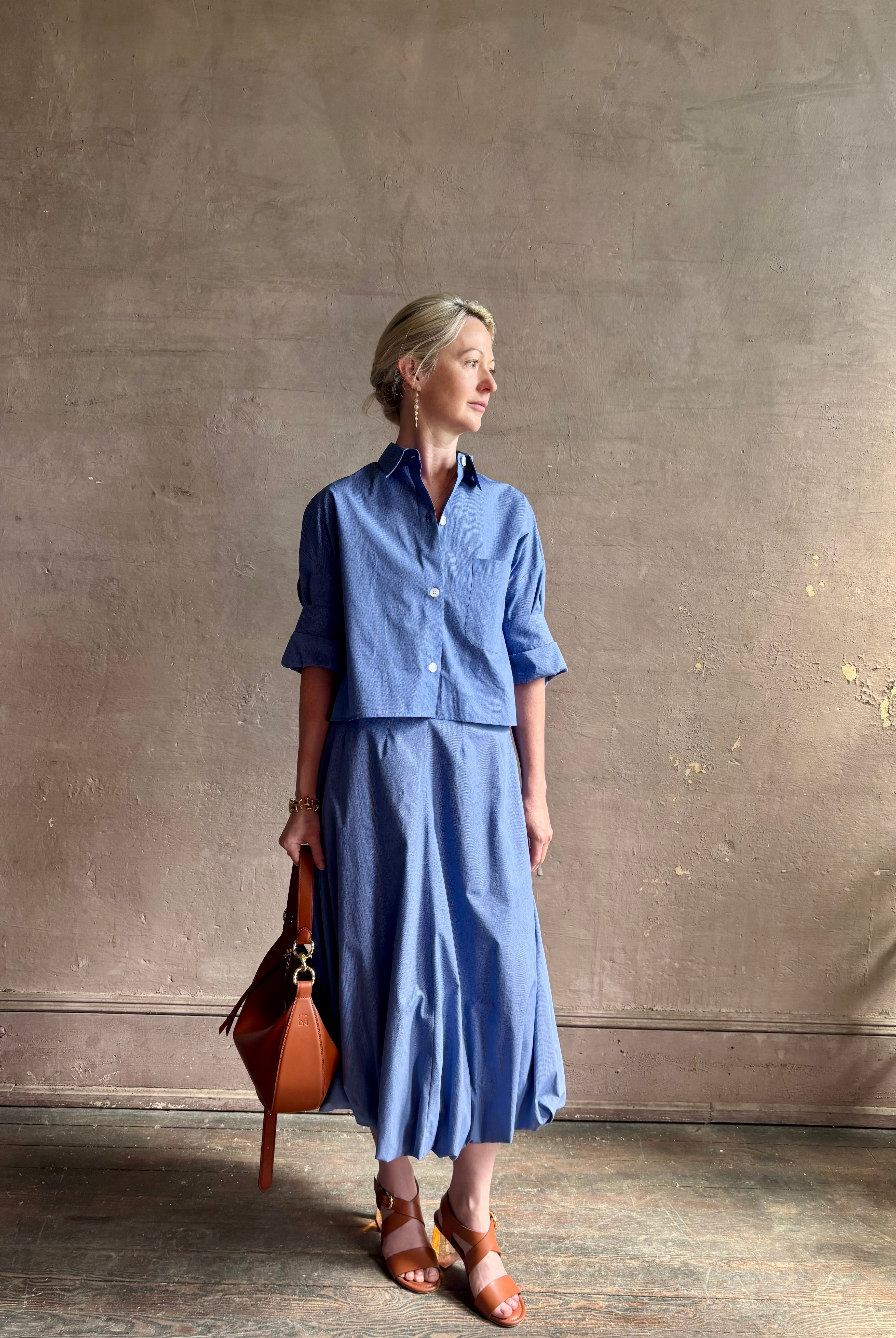 mature model wearing classic cotton poplin button down next ex top by luxury brand TWP in a blue and white