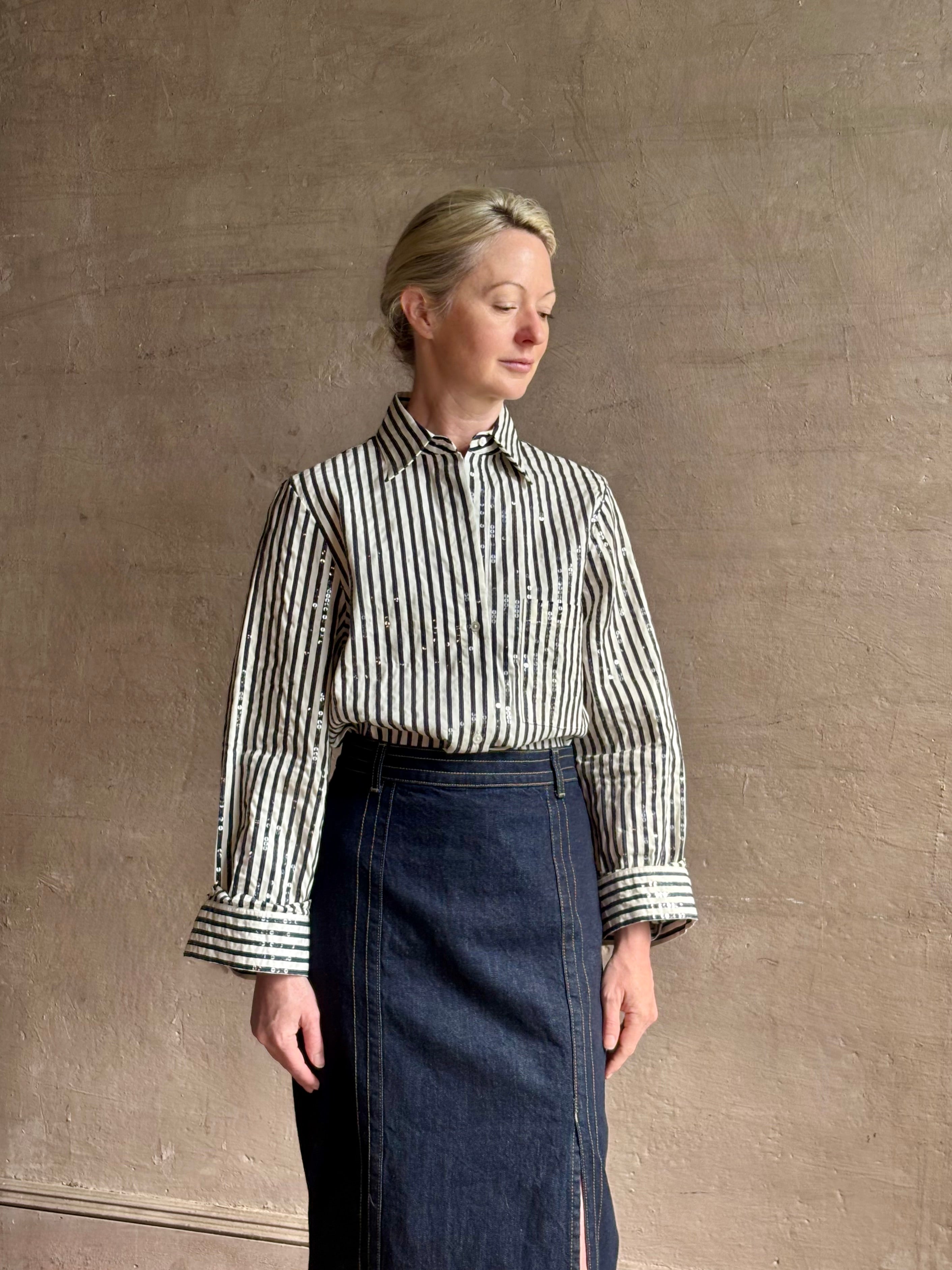 Mature woman wearing TWP premium cotton-blend button down indigo striped shirt with sequins, long sleeve and collar