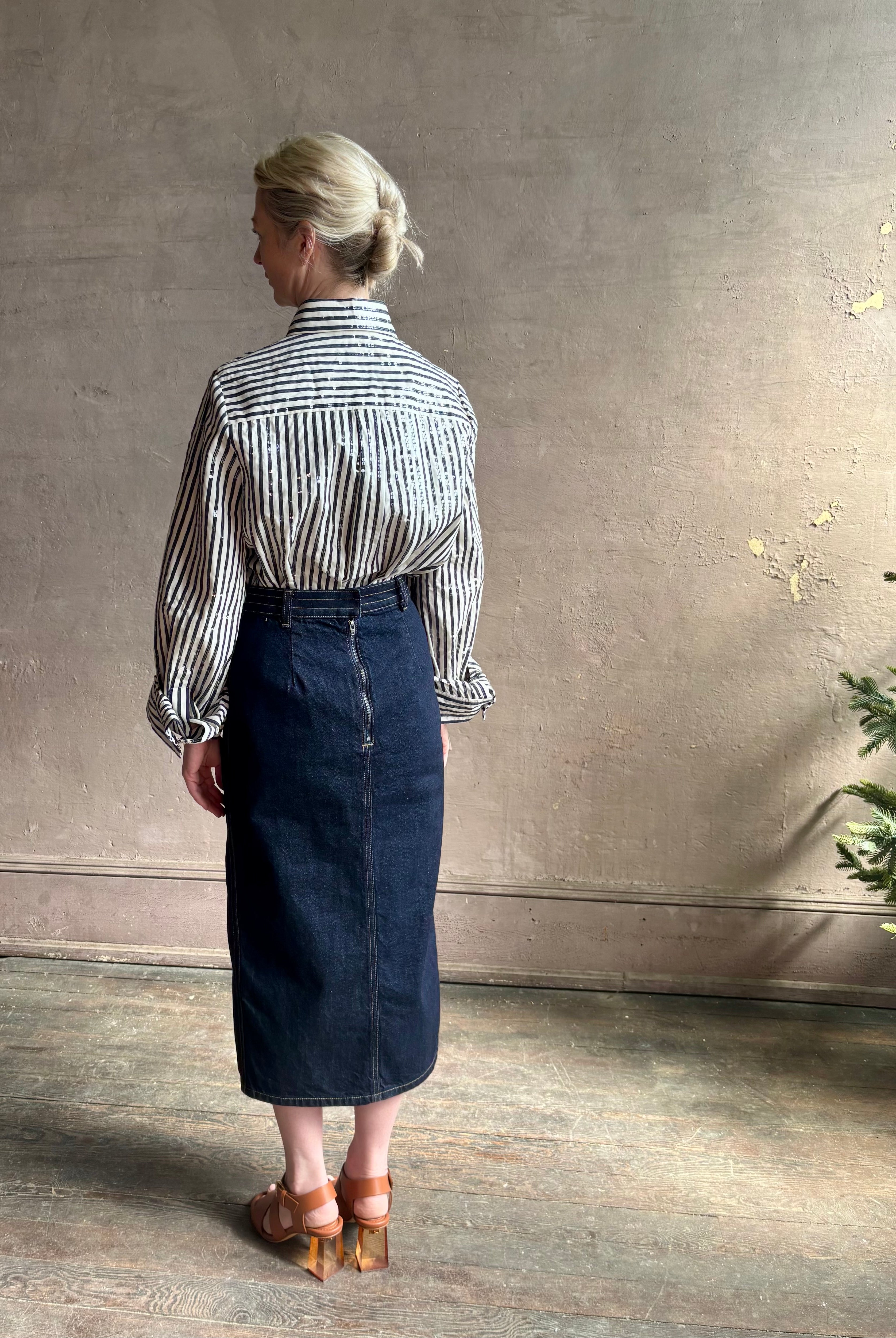 Mature woman wearing TWP premium cotton-blend button down indigo striped shirt with sequins, long sleeve and collar