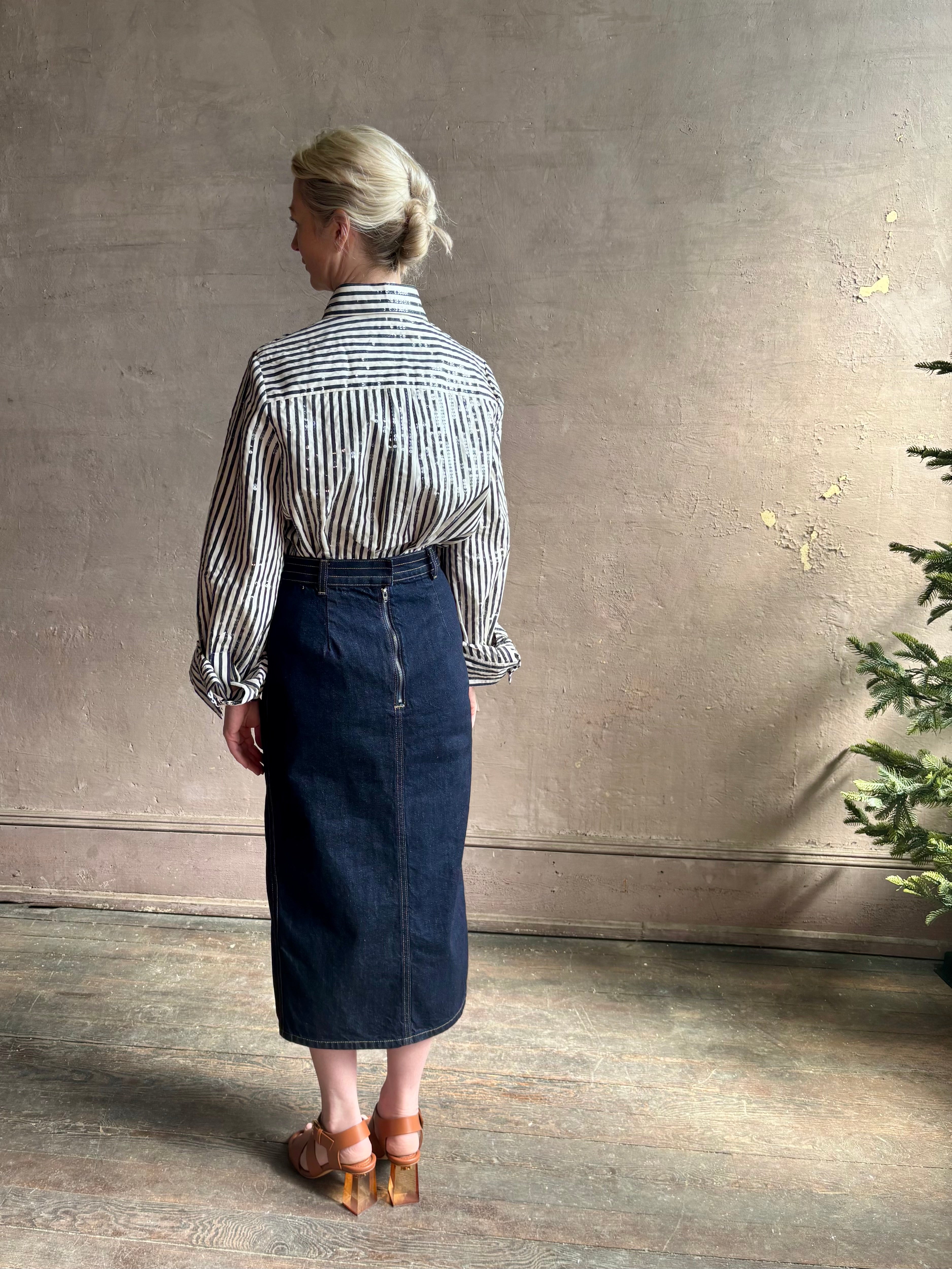 Mature woman wearing TWP premium cotton-blend button down indigo striped shirt with sequins, long sleeve and collar