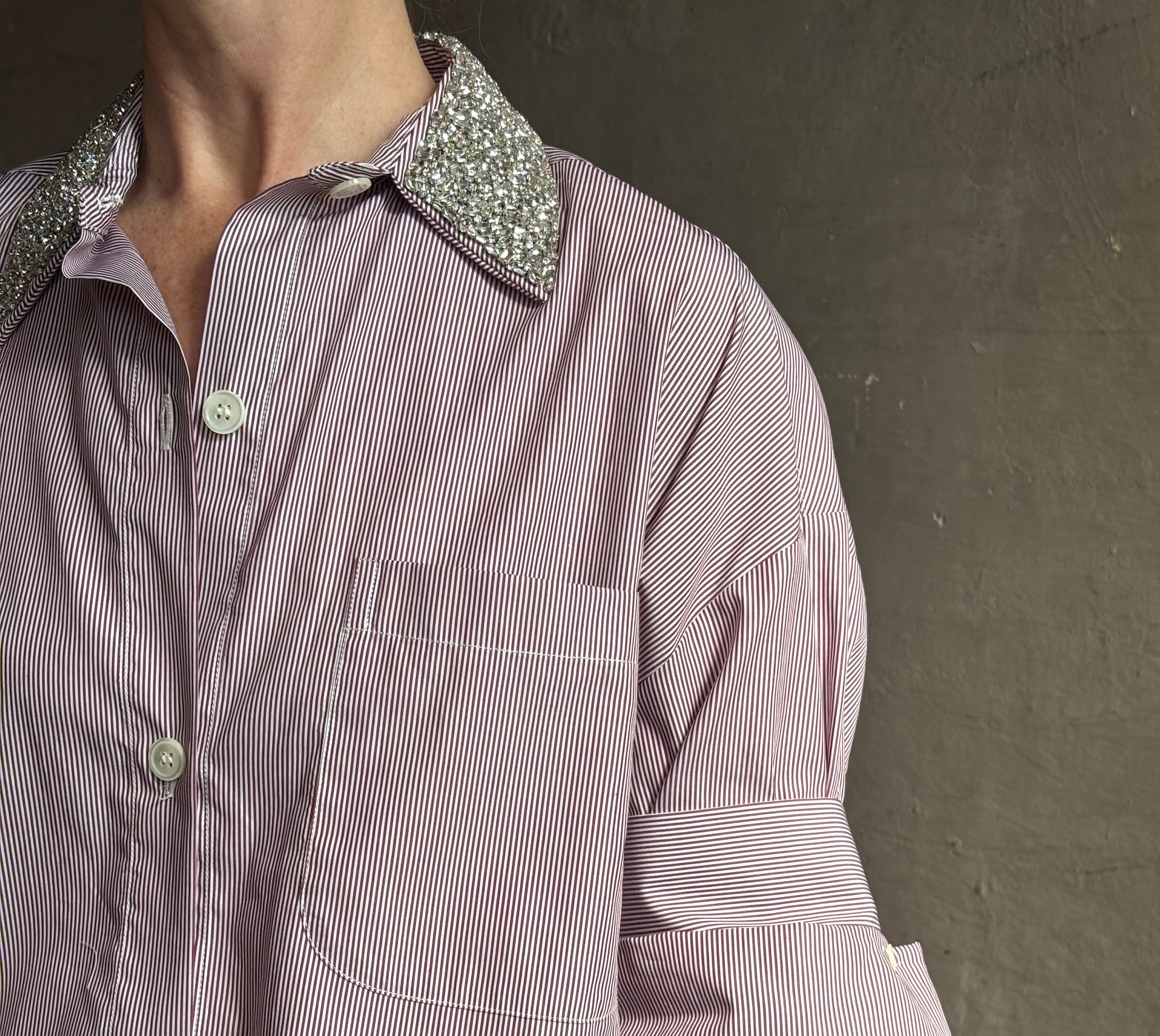 Image of mature woman wearing sophisticated TWP Next EX cotton shirt with elevated Crystal embellished Collar in White and wine stripe made in USA