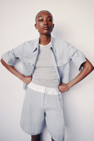 Image of model wearing luxury TWP New Carter indigo Button Up hemp top combining timeless workwear with contemporary refinement