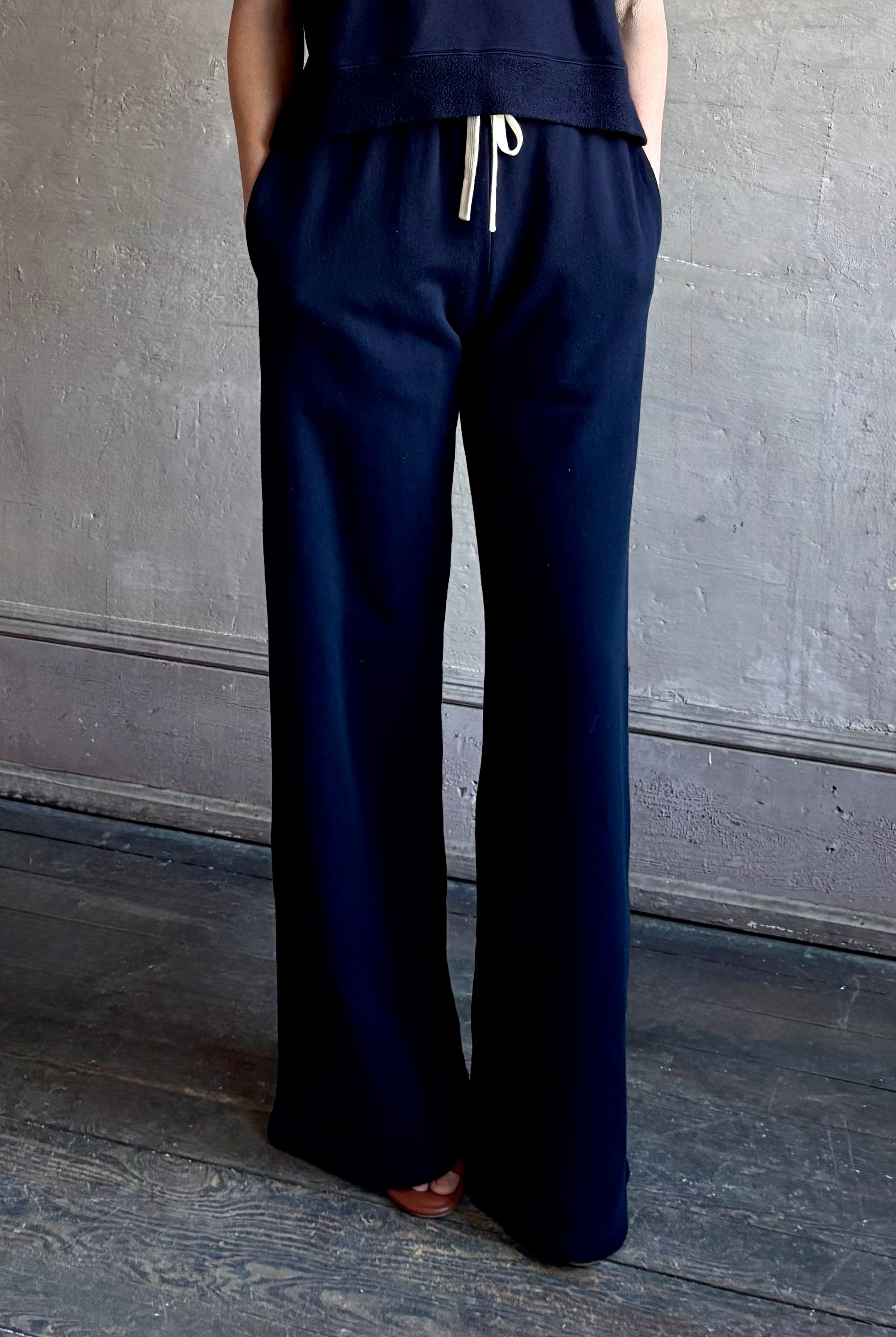 Mature woman wearing the PJ Pant from TWP is a luxuriously relaxed women's designer lounge pant crafted from cotton with a straight leg and effortless pull-on waist