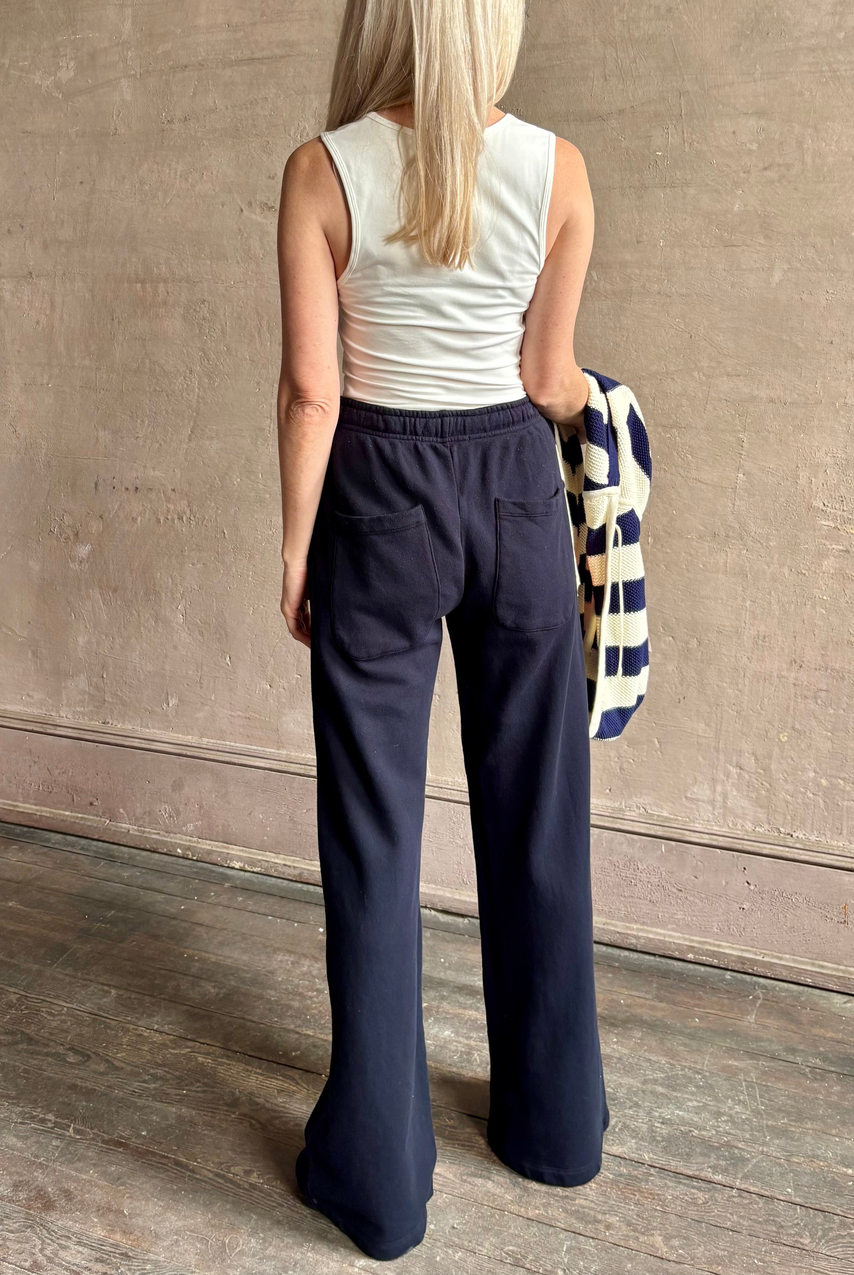 Mature woman wearing the PJ Pant from TWP is a luxuriously relaxed women's designer lounge pant crafted from cotton with a straight leg and effortless pull-on waist
