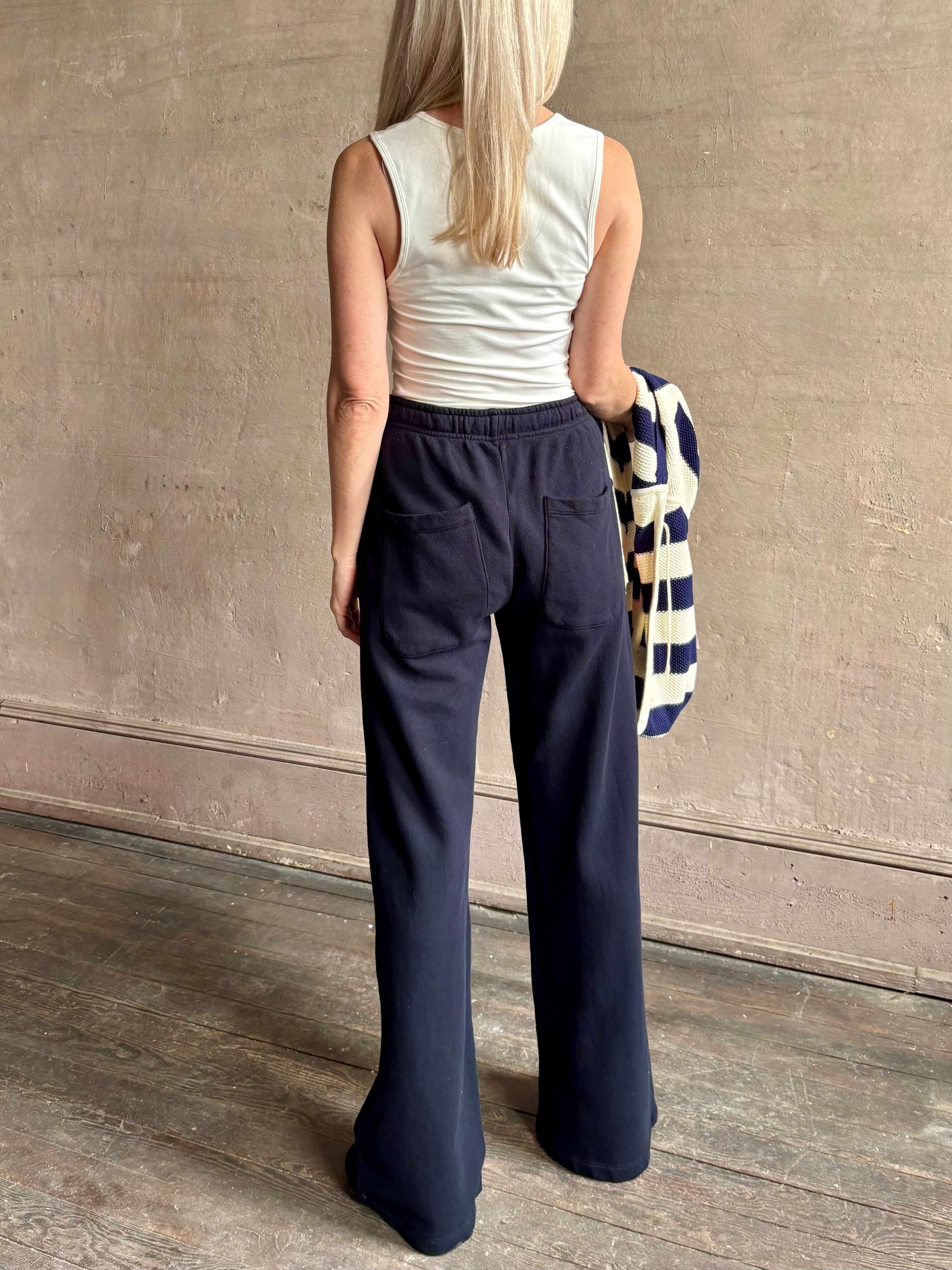 Mature woman wearing the PJ Pant from TWP is a luxuriously relaxed women's designer lounge pant crafted from cotton with a straight leg and effortless pull-on waist