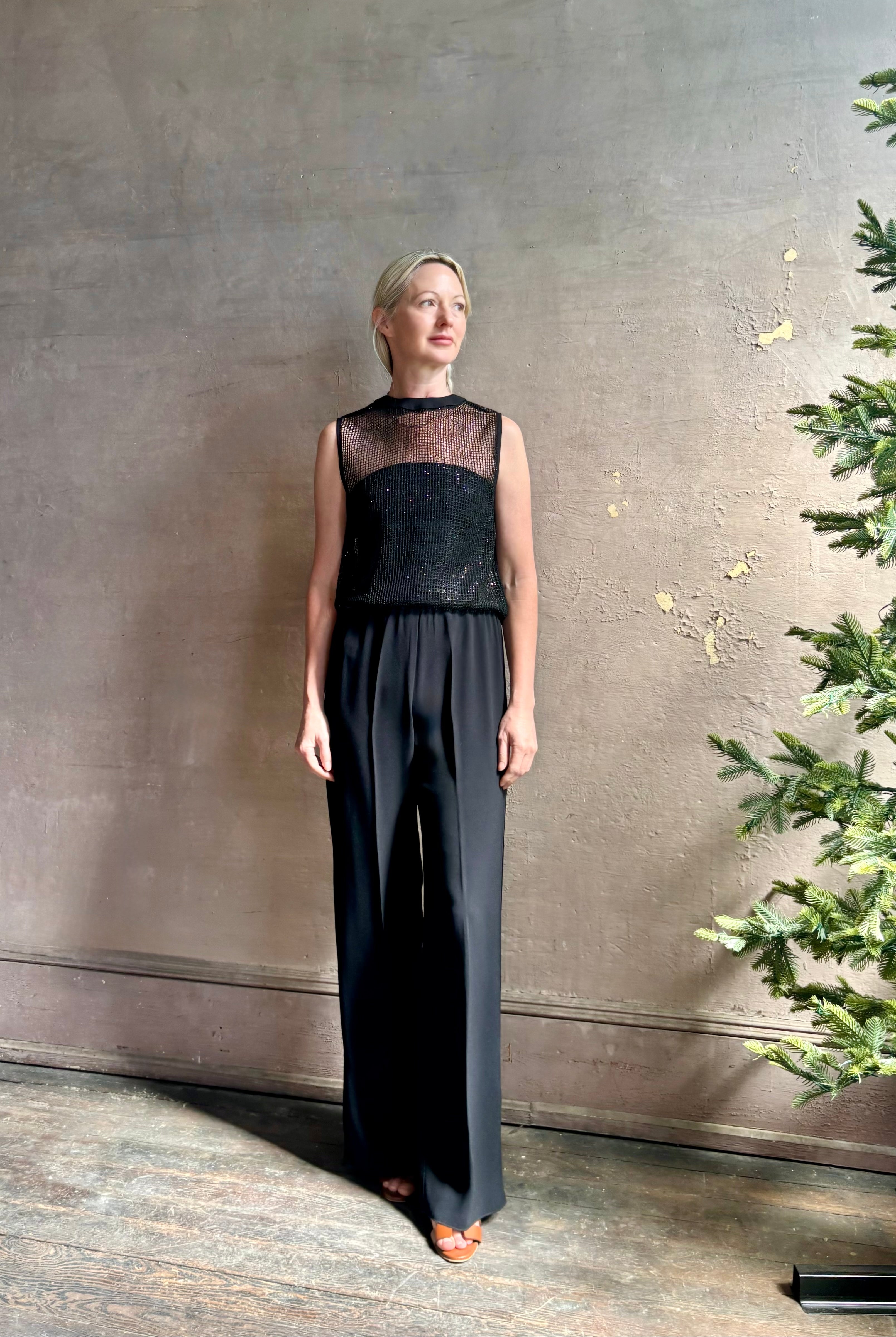Image of mature woman wearing Women's designer clothing label TWP short muscle tank in black with subtle sequin embellishments perfect for luxury layering