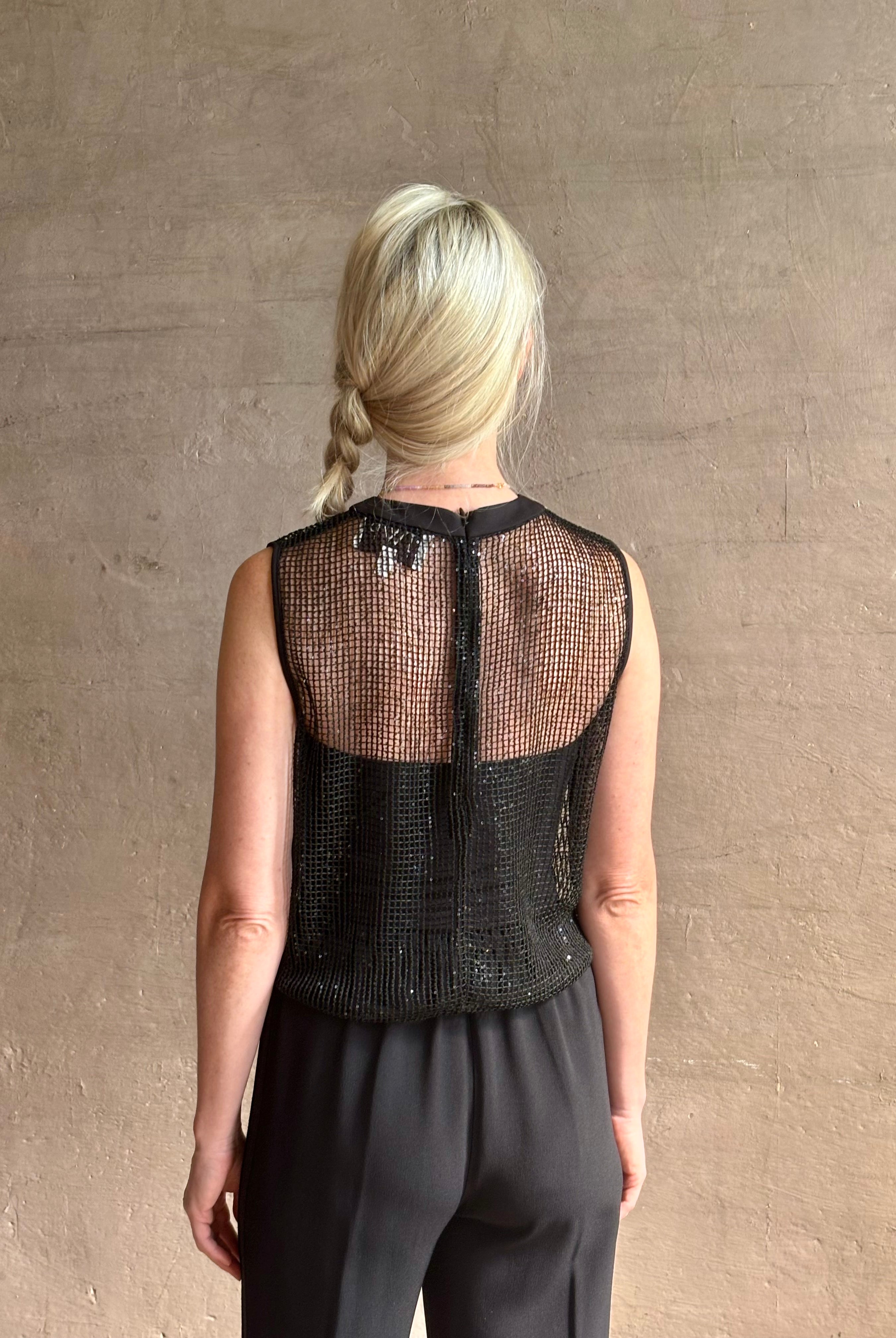 Image of mature woman wearing Women's designer clothing label TWP short muscle tank in black with subtle sequin embellishments perfect for luxury layering