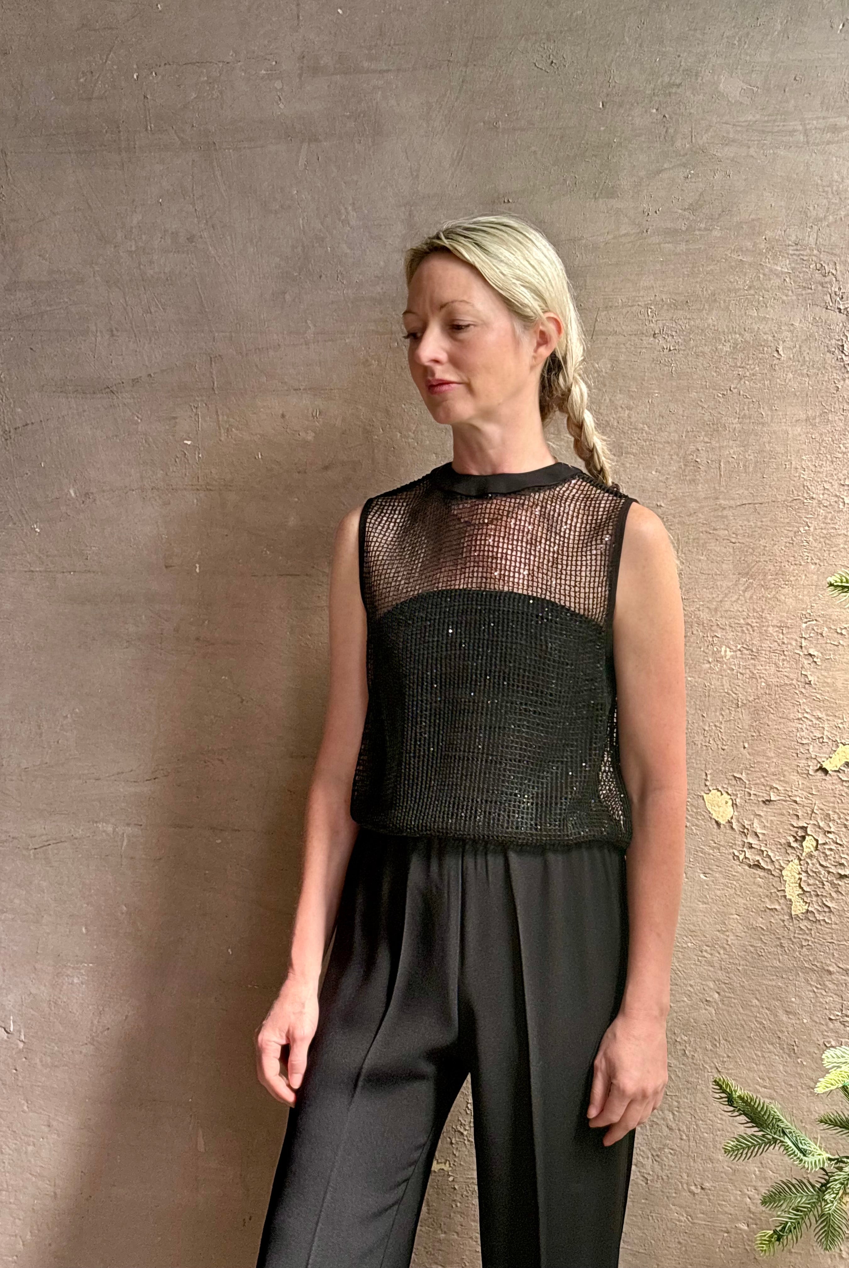 Image of mature woman wearing Women's designer clothing label TWP short muscle tank in black with subtle sequin embellishments perfect for luxury layering