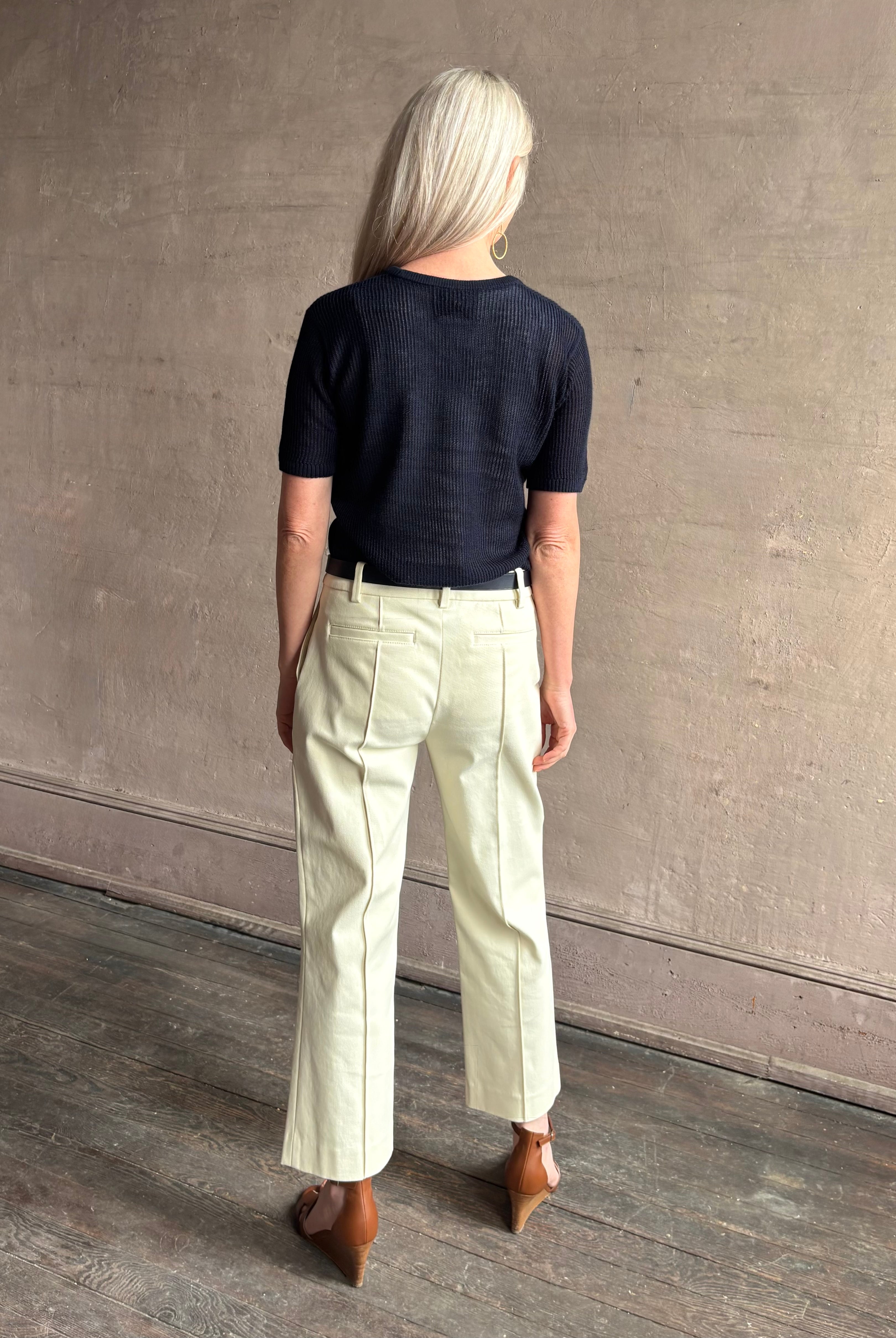 Mature woman wearing luxury Short Sleeve navy blue cashmere Tee Sweater from TWP with open weave and crew neck