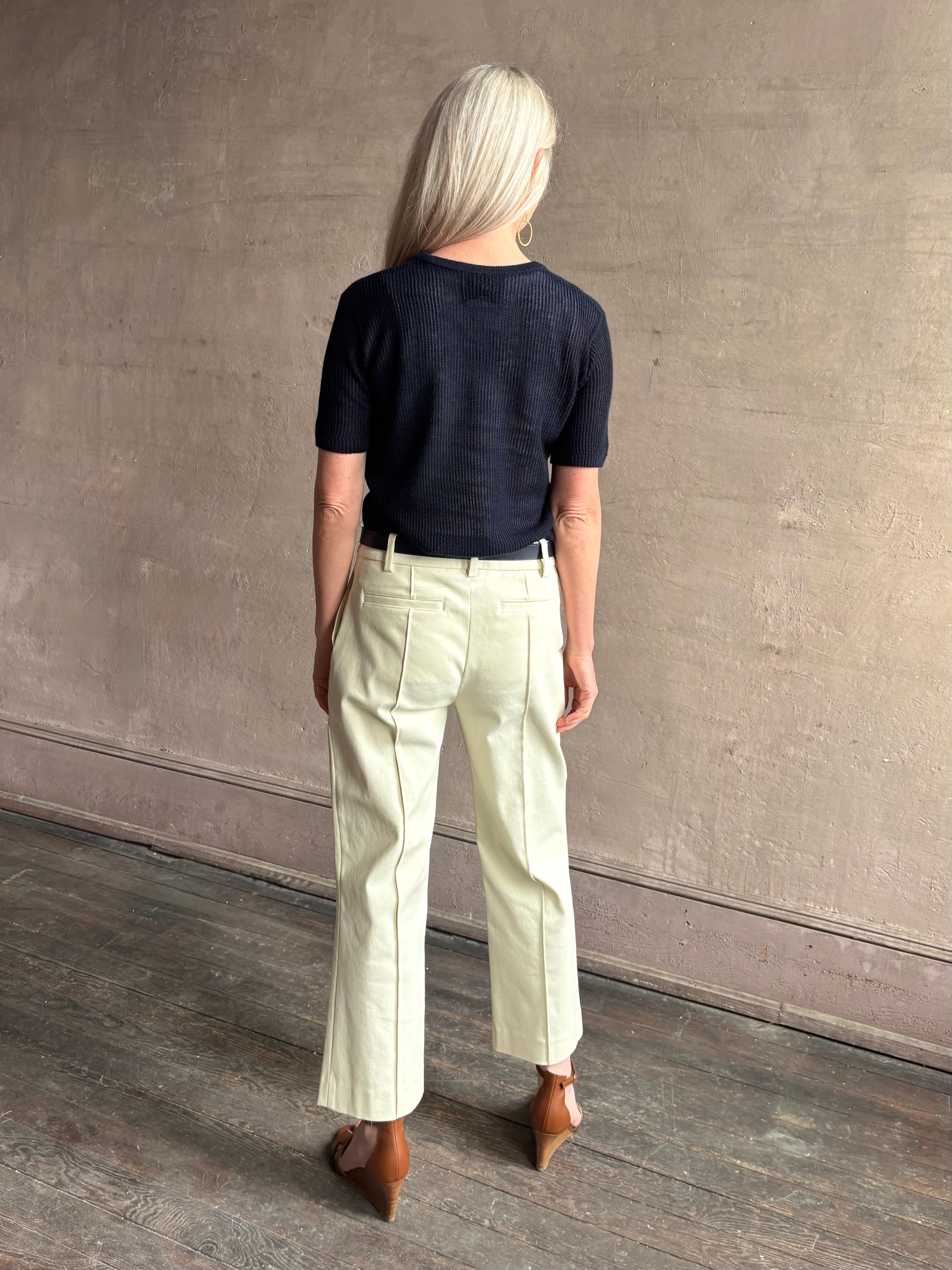 Mature woman wearing luxury Short Sleeve navy blue cashmere Tee Sweater from TWP with open weave and crew neck