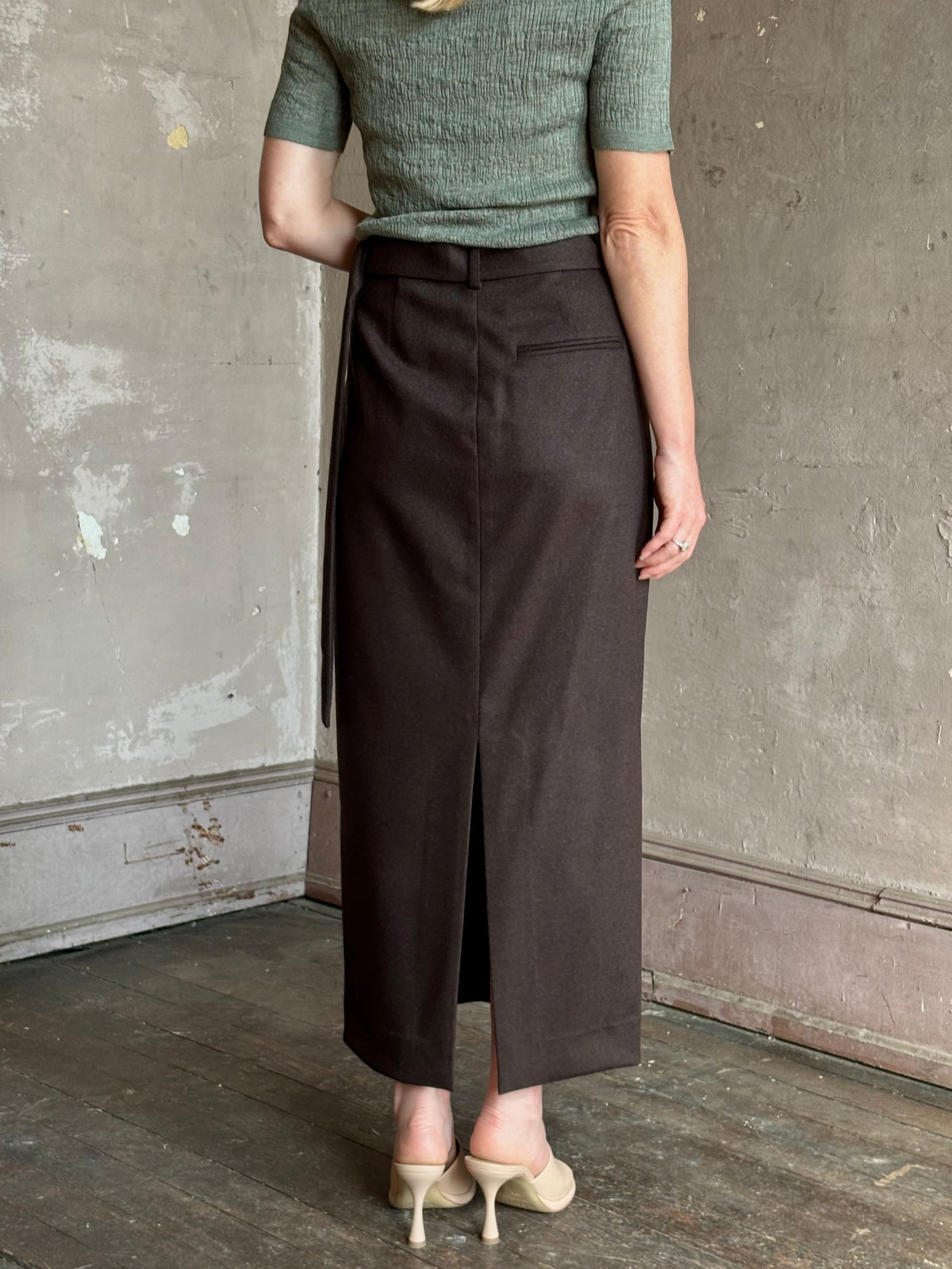Mature woman wearing elegant TWP slit pencil skirt wool chocolate brown elevated tailored maxi skirt