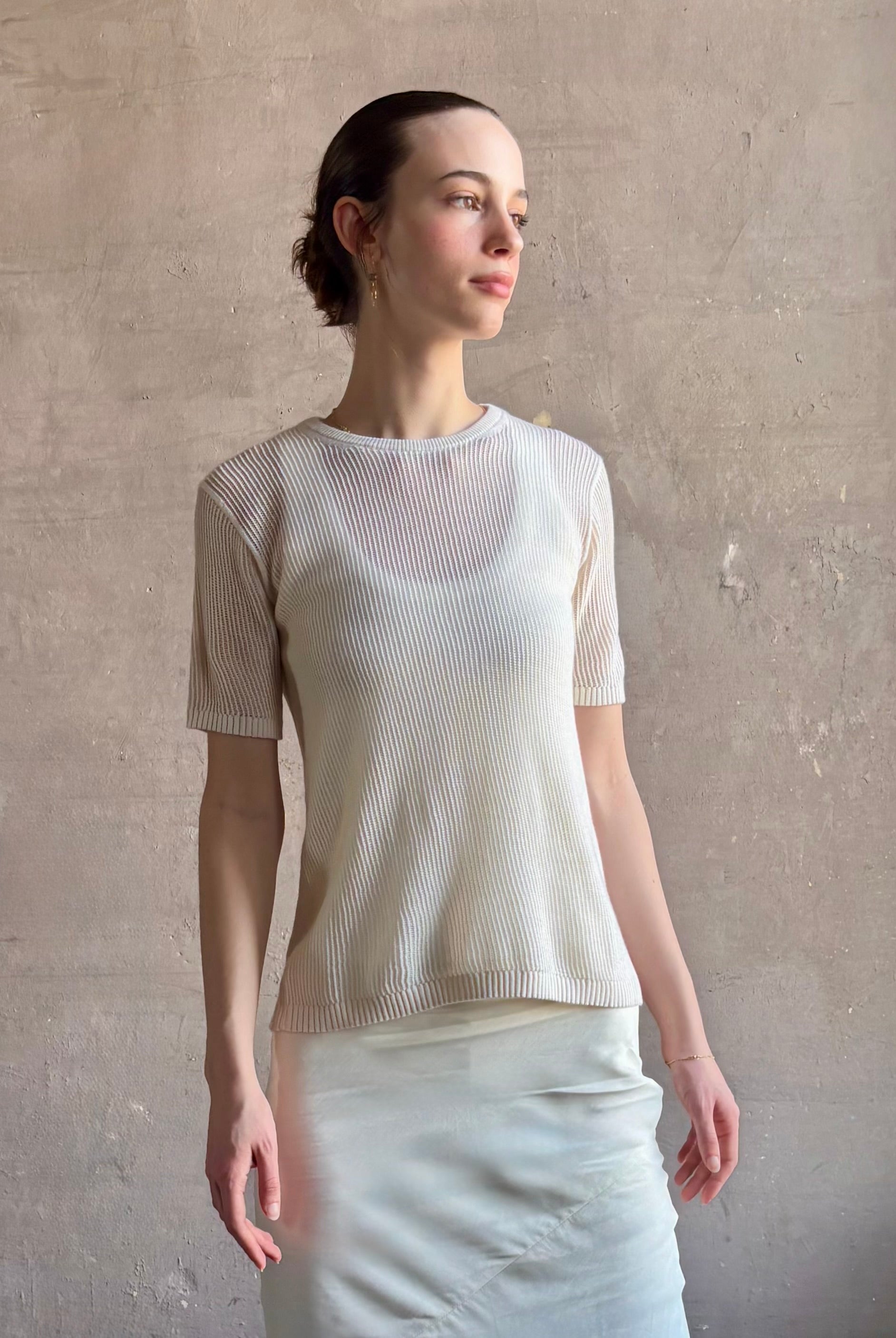 Woman wearing luxury designer TWP Short Sleeve premium knit lightweight cashmere Tee top in Ivory with crew neck and short sleeves
